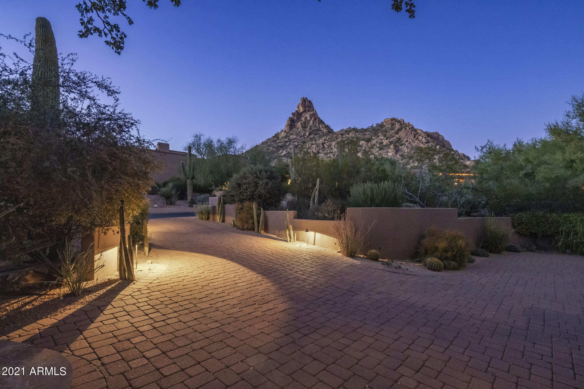 ''Classic Contemporary Southwest Elegance'' defines this stunning custom home located in prestigious Desert Highlands, situated on a private corner North/South facing lot offering spectacular views of Pinnacle Peak, Troon & McDowell Mountains. This custom built & designed masterpiece is nestled at the base of Pinnacle Peak offering 3 split bedrooms, state of the art media room with exquisite cabinetry & architectural ceiling, living room facing Troon & McDowell Mountains with honed granite gas fireplace & coffered ceiling, office study facing Pinnacle Peak with stone paneled wall & wood trimmed ceiling, great room open floor plan with architectural ceiling & stone gas fireplace and sit up wet bar, dining room with custom cabinetry & coffered ceiling, southern exposure outdoor living space perfect for al fresco dining, complete with heated pool & spa, fire element, & endless views of Troon & McDowell Mountains. The custom finishes selected include white oak flagstone floors with pebble stone details, custom wood beam & stone & coffered ceiling details, custom window treatments throughout, custom cabinetry with handmade hardware throughout. The open kitchen includes granite countertops, custom metal accents at vent hood and cabinetry, stainless steel Decor 6 burner gas range with double oven, Décor wall oven & built-in microwave, Sub Zero paneled refrigerator/freezer, dual sink & separate vegetable sink, two Asko dishwashers, walk-in pantry, breakfast bar overlooking the great room, bar & breakfast nook, custom designed temperature control wine storage cabinet, butler's pantry with sink, stone & wood trimmed vaulted ceiling & custom cabinetry,. The media room with its dramatic custom cabinetry, wet bar, & architectural ceiling is perfect for that highlighted football game or newest movie release with Epson 4K projector and 100-inch Stewart Grayhawk screen and 5 speaker Dolby Surround Sound. The master bedroom retreat invites you into elegant finishes including stone panel walls, architectural ceiling, and a large sitting room with Troon Mountain views. The master bathroom offers large jacuzzi whirlpool soaking tub, walk-in stone & custom glass shower with dual sink consoles with oil rubbed bronze vessel sinks. This move-in ready property is the ultimate desert elegant retreat to enjoy the sunny Arizona desert lifestyle. Residents/members of Desert Highlands Golf Club enjoy community club amenities including a Jack Nicklaus Signature golf course, 10,000/sf state of the art fitness center, 13 tennis courts including 4 grass, pickle ball courts, bocce ball courts, clubhouse with fine & casual dining, guard gated & security patrol. Buyer to pay mandatory Desert Highlands Club Membership of $95,000 at close of escrow. $1,395/monthly HOA fee includes club dues, golf green fees for immediate family members under 25.