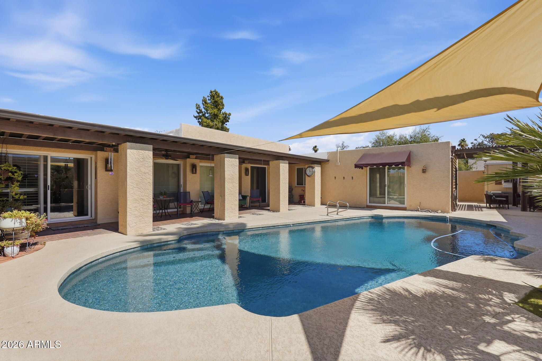 Welcome to Your Private Oasis in the Heart of Tempe! Steeped in timeless charm and elevated by modern luxury, this stunning villa-style residence offers the perfect blend of architectural character and contemporary comfort. From the moment you arrive, the villa's striking silhouette sets the stage for something truly special.
Step through the brand-new, upgraded entry doors and into a sun-drenched sanctuary.  Designed to maximize Arizona's beautiful natural light, the home features an abundance of newly replaced, energy-efficient windows and strategically placed skylights that bathe the entire interior in a warm, welcoming glow. At the heart of the home is a spectacular, fully renovated kitchen that flows effortlessly into the expansive dining and family room areas. This open-concept floor plan is an entertainer's dream, allowing conversations to flow seamlessly from the chef's prep station to the social hubs. The kitchen itself boasts premium finishes, crisp cabinetry, and sleek new countertops. After hosting, retreat to the cozy family room, where a beautiful fireplace serves as the perfect centerpiece for cool desert evenings. 
The primary owner's suite is a true masterclass in residential design. The highlight is the completely transformed en-suite bath, featuring a luxurious, newly completed shower that opens up to a private, sun-lit atrium. It's a spa-like, indoor-outdoor experience right in the comfort of your own home. Step out back into your ultra-private backyard paradise. The sparkling pool and surrounding pool deck have been completely resurfaced, offering a pristine, resort-quality setting for summer pool parties or quiet morning coffees. New pergola, misting system and hot tub make this backyard paradise ideal for year round use! This home is located in one of Tempe's most desirable pockets minutes from world-class dining, shopping, major employers, and excellent schools. Don't miss the opportunity to own this beautiful home. Schedule your private tour today!