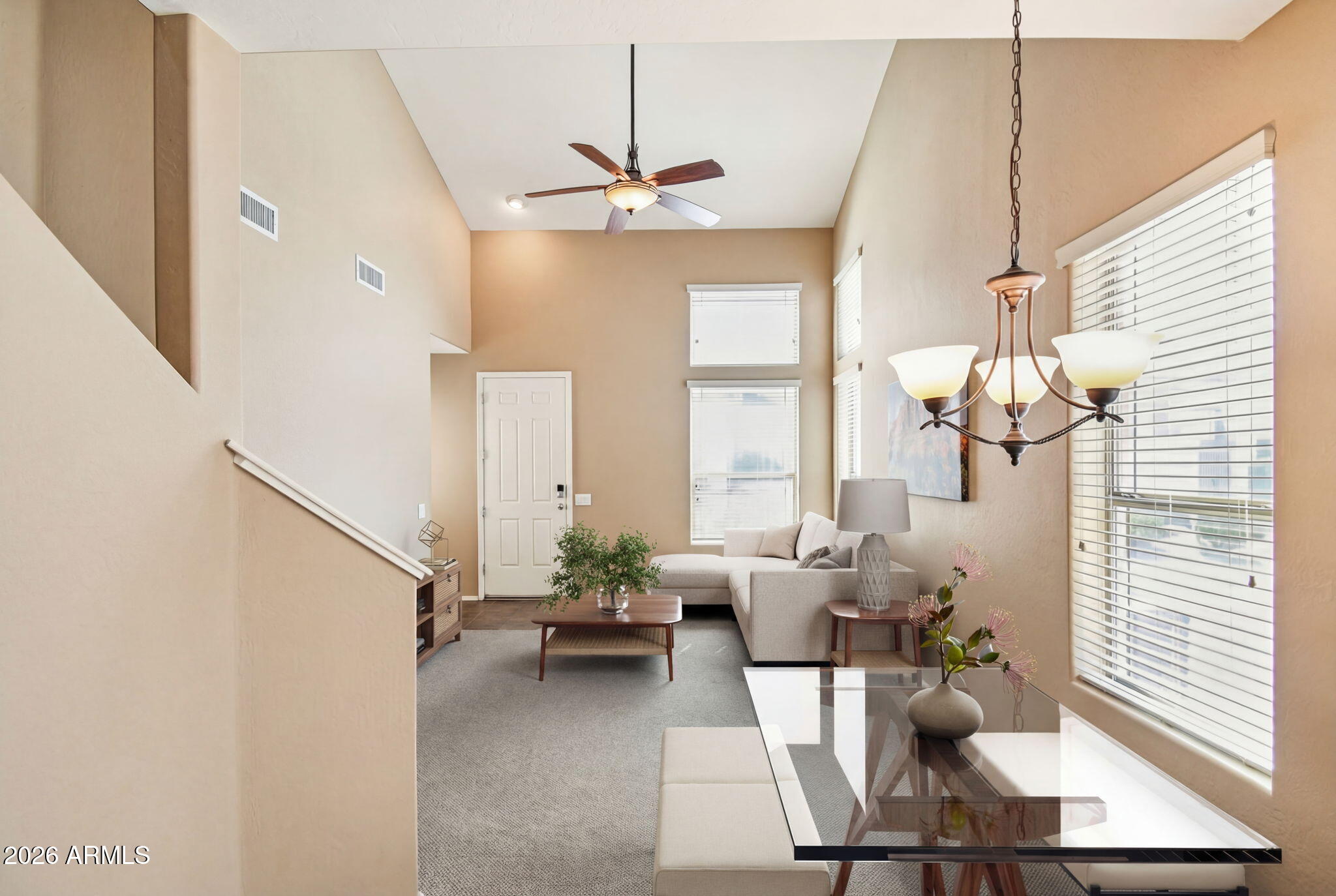 Welcome to the Villages, where residents enjoy lock and leave living in private gated community. Water, sewer, trash, roof replacement, exterior painting & maintenance, landscaping are included in HOA. Plus a private gym, pool & spa for residents, along w/access to all Anthem parkside amenities AND lower insurance rates (only a wall-to-wall policy needed). This desirable 2 bedroom plus loft, 2.5 bath end-unit offers natural light, comfort and convenience. Primary bedroom downstairs with patio access, a walk-in closet and en-suite bath. 2-car garage (full-size truck fits), walk-in pantry, pull-out trash & shelves and downstairs half bath for guests. Enjoy newer A/C! Ideally located near shopping, medical & dining. This home is the perfect blend of low-maintenance living & everyday comfort.