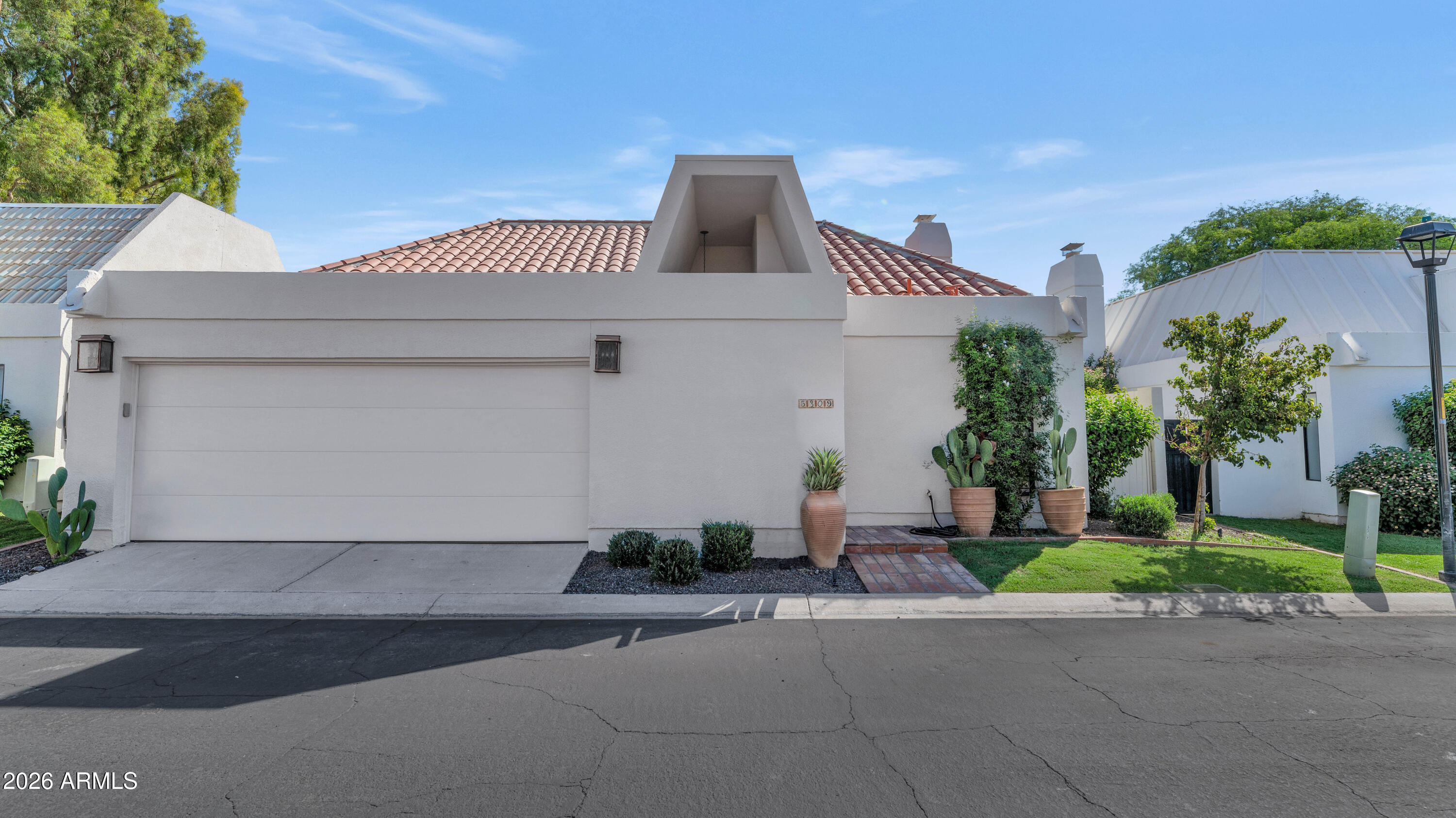 Located in a prestigious gated community at the world-renowned Arizona Biltmore, this beautifully remodeled patio home offers luxury living at its finest. Recently updated throughout, the fresh finishes feature elegant wood flooring, stunning quartz countertops, sleek marble accents, sparkling crystal chandeliers, and chrome fixtures. The custom kitchen has white cabinetry complemented by a full suite of upgraded appliances. The spacious great room is highlighted by soaring vaulted ceilings, a lovely fireplace, and sliding glass doors that open to the private patio, creating the perfect indoor-outdoor living experience. There are spacious formal and informal eating areas, and the generous primary suite serves as a tranquil retreat with a spa-inspired bath featuring marble finishes, a... ...large walk-in glass-enclosed shower, and luxurious designer touches. The private, low maintenance, yet great looking backyard features a beautiful pool and entertaining spaces that provide an ideal setting for outdoor dining, relaxing, and enjoying drinks in or out of the pool. This exceptional home combines great taste, modern upgrades, and an unbeatable location in one of Arizona's most iconic luxury communities.