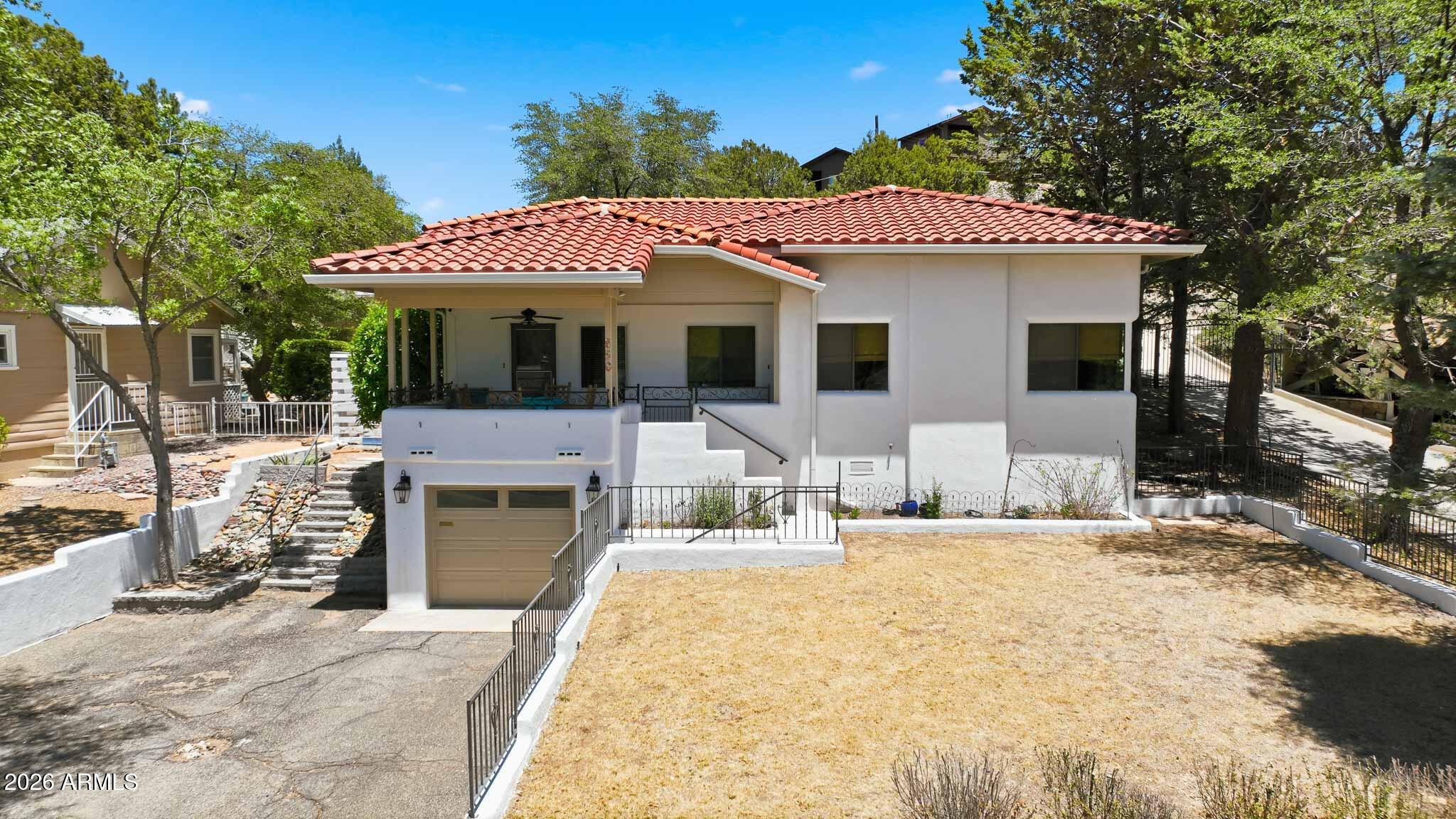 RARE Historic District gem in the heart of Prescott! This charming Mediterranean-style home is within walking distance to the Courthouse Square, Whiskey Row, restaurants, shopping, and entertainment. Offering approximately 1,650 sq. ft., this unique property is filled with character featuring hardwood floors, tiled bathrooms, arched doorways, and timeless architectural details throughout. The spacious primary suite includes private patio access, perfect for relaxing and enjoying Prescott's cool mountain air. Enjoy peaceful mornings on the covered front patio surrounded by mature landscaping and historic charm. Ideal as a primary residence, second home, or vacation retreat in one of Prescott's most desirable locations. Some of the updates by the owners include: smooth coat texture on all walls and ceilings, fresh interior paint, refinished floors, new interior doors and hardware, new water heater, gas stove, and refrigerator. The bedrooms feature new carpet, while the hall bath has been updated with new tile flooring. The kitchen offers painted cabinetry and new countertops, creating a fresh, modern feel. Outside, enjoy the freshly painted front patio with charming ornate iron railing, adding great curb appeal and a welcoming place to relax.