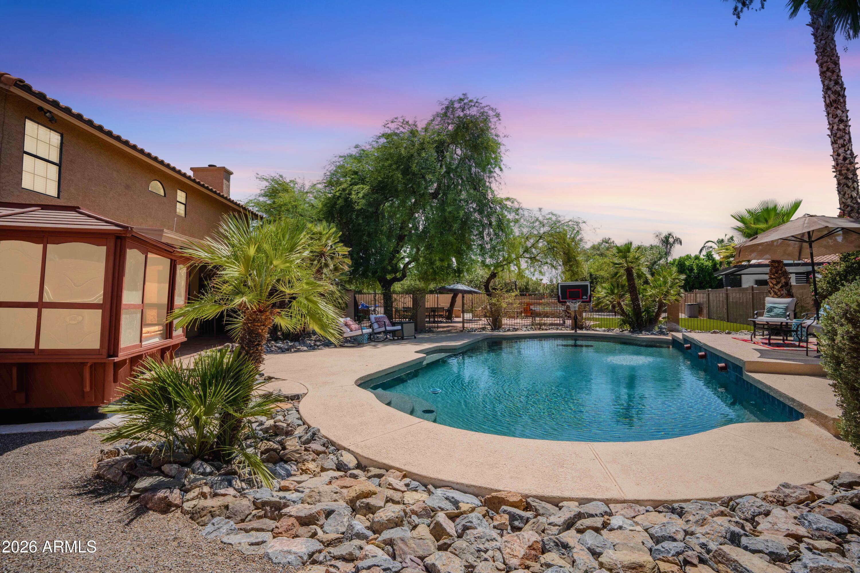 Tucked into a quiet cul-de-sac in one of Scottsdale's most sought-after neighborhoods, this 5-bedroom, 2.5-bath home was made for family living. Set on over a third of an acre, the backyard is a kid's dream and a parent's paradise: large pool and hot tub in a private gazebo, a cozy fire pit, built-in BBQ, and a huge turf area, large spaces for basketball, pickleball, and endless play. A versatile bonus room converted from the garage is perfect for guests, grandparents, or a mother-in-law suite. Surround sound brings the living room, bonus room, and primary bedroom to life. Fully owned solar cuts the electric bill by more than half. With top Scottsdale schools, parks, and dining nearby, this is the family home you've been waiting for!