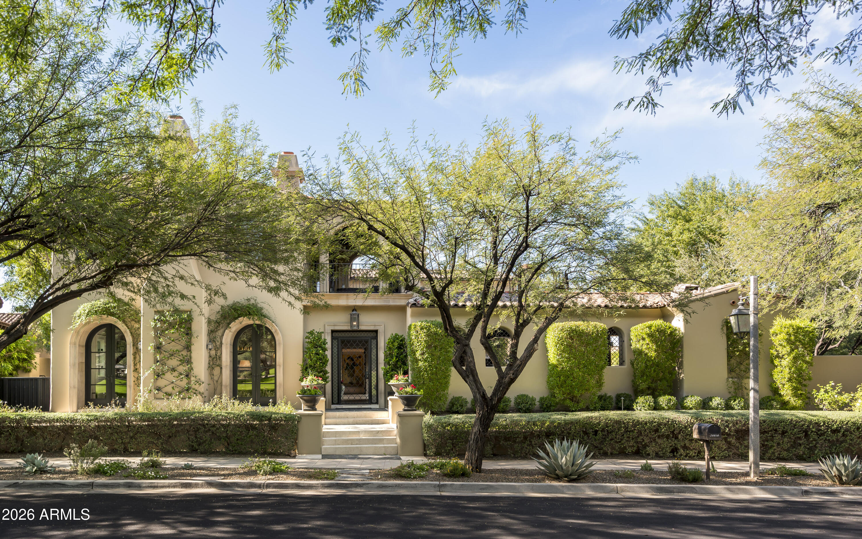 Ideally positioned in Windgate Pass overlooking the fully stocked lake and expansive lawns of Desert Spring Park. One of only a limited number of homes with this direct frontage, the residence enjoys water, mountain, city light, and garden views from nearly every room, along with four enclosed balconies that extend the living experience outdoors. The 8,030 SF home was thoughtfully remodeled with the guidance of renowned interior designer Kim Scodro, resulting in a refined yet comfortable aesthetic and a series of high-level enhancements. Notable additions include an approximately 1,800-bottle, temperature-controlled wine cellar, a dumbwaiter elevator, and numerous custom details throughout. The chef's kitchen is both functional and elegant, featuring a generous island, handcrafted cabinetry, and a walk-in butler's pantry designed to support both daily living and entertaining. Four spacious en-suite bedrooms include the primary suite, which offers a tranquil sitting area, a well-appointed bath with a steam shower, and an expansive walk-in closet with integrated laundry facilities.

Designed for entertaining, the home includes a sophisticated bar adjacent to the wine cellar, complete with dual wine refrigerators, dishwashers, and automated shades. Guests are comfortably accommodated in the two-room guest casita, featuring a fireplace and an inviting sitting area. Additional highlights include a potential eight-car, air-conditioned garage and a resort-style outdoor living area with pool, spa, outdoor kitchen, covered patio, and an enclosed outdoor bathideal for enjoying Arizona's indoor-outdoor lifestyle.

With its rare lakefront setting, refined design, and prime Windgate Pass location, this residence offers a truly special opportunity within the Silverleaf community.