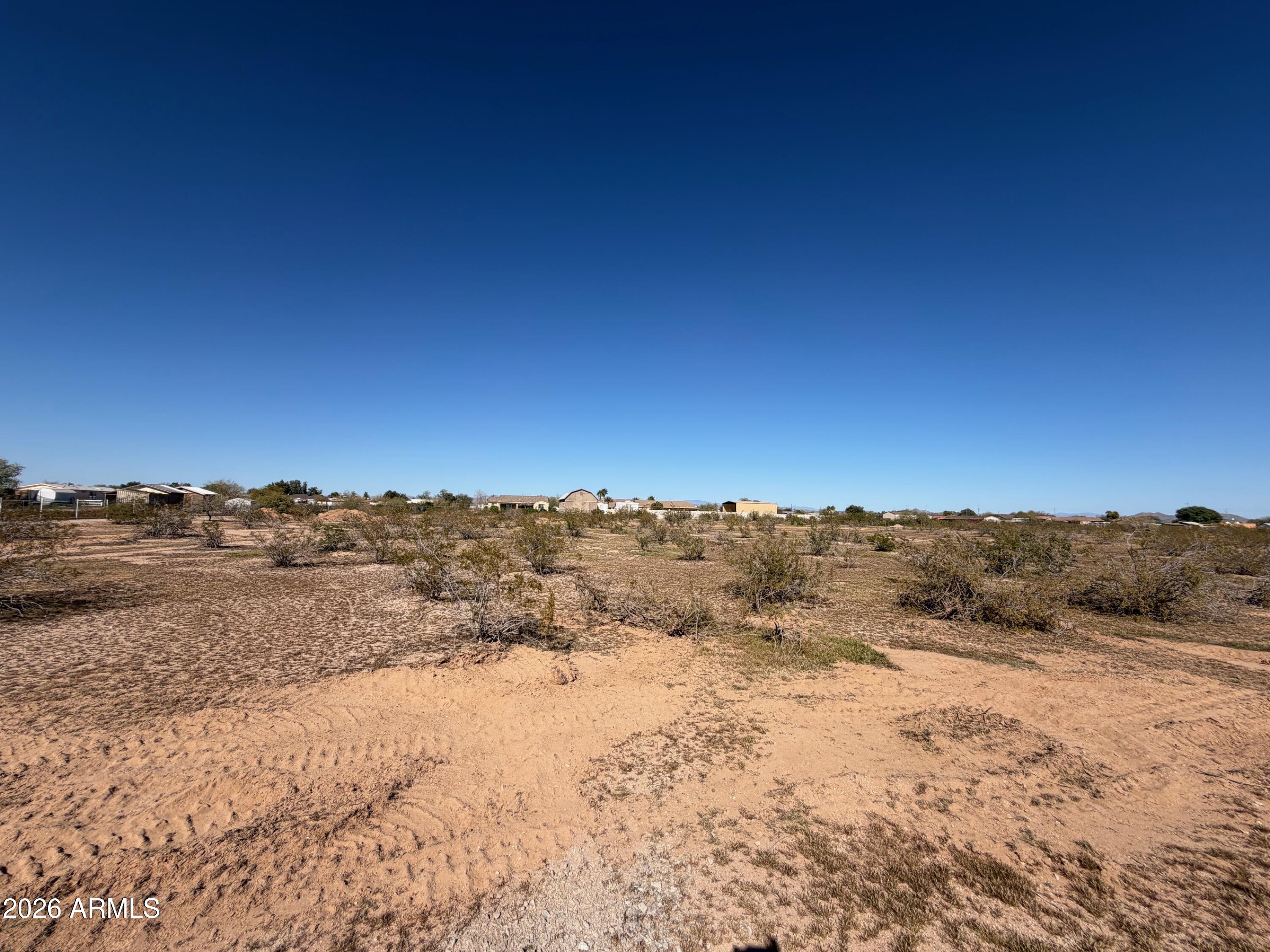 Exceptional 5.24 ACRE flat, buildable lot in growing Wittmann, AZ. Keep all 5 acres for your personal compound or split and sell for investment. Great builder opportunity! WELL IN! Electric near. NO flood zone, washes or Luke AF APZ.  Surrounded by custom homes/ranches. Room for spacious home PLUS RV garage PLUS guest house PLUS horses and all the toys. No HOA, but deed restricted to site-built homes 1900+sf.  Improved road and shared easement to parcels. Approx 1 mile to US 60 -- EZ access to 303, Lake Pleasant, Shopping, Dining, and a quick trip to Vegas. Buyer to verify all info. Septic will be needed. Seller may carry, ask for terms.