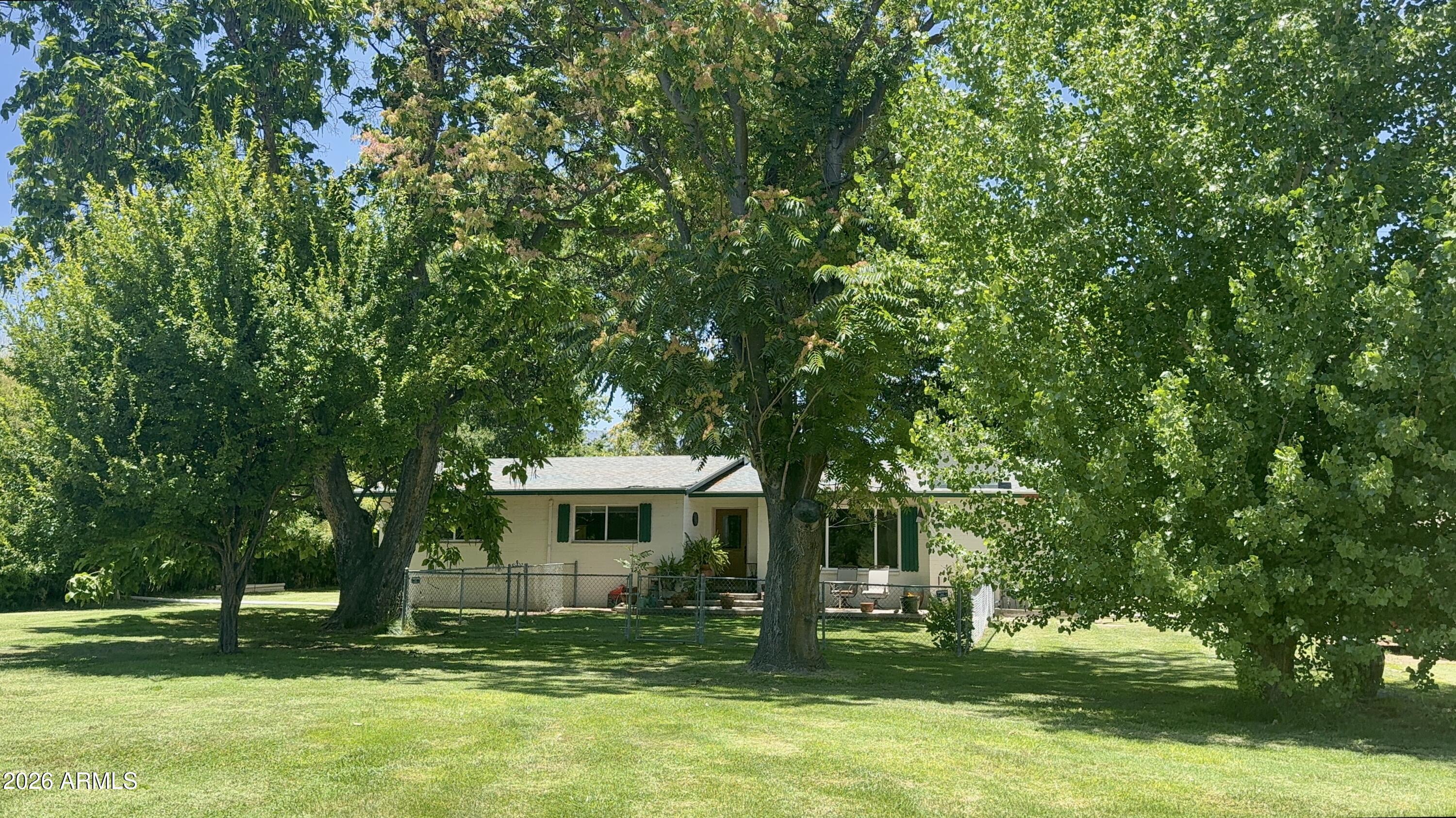 Charming 1960 single-level ranch on .89 acre in a quiet corner of Cottonwood -- no HOA, no compromises. 

This 3BR/2BA home offers approximately 1,600 sq ft of comfortable living space with major systems already updated: new HVAC, new roof, and brand-new windows throughout, plus a refreshed kitchen ready for your finishing touches.

Step outside and the real magic begins. Towering shade trees -- including a massive nut-bearing pecan and a statuesque mature white oak -- canopy the property alongside fruit trees, creating a private, park-like setting that's rare to find. Flood irrigation keeps the grass lush and green with minimal effort, and the .89 acre lot leaves plenty of room to expand, garden, or simply spread out.

Hosting family or friends with RVs? Two RV hookups ready to use.