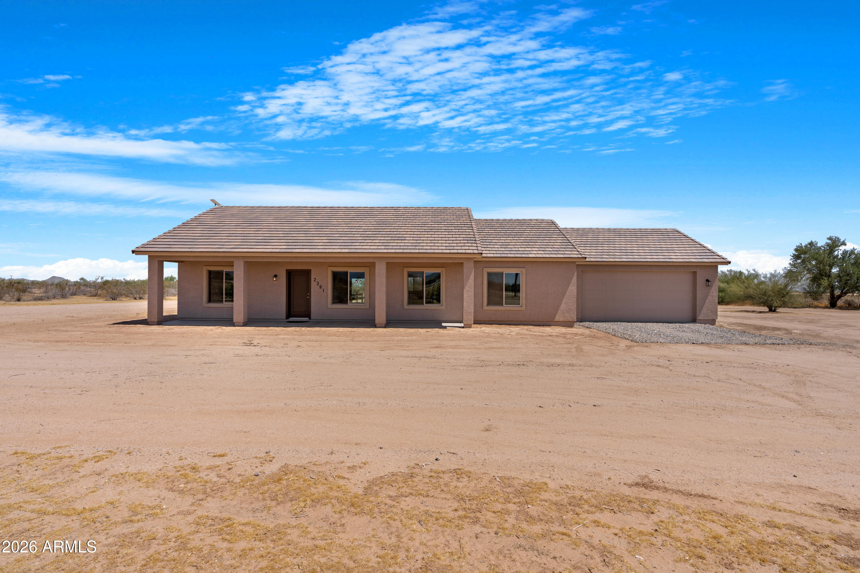 Escape to wide-open space and quiet star filled skies with this beautiful 3-bedroom, 2-bath home set on a large country lot with no HOA! Inside, a light-filled great room welcomes you with vaulted ceilings,  open-concept living and dining under soaring vaulted ceilings. Stylish kitchen features a large island, quartz countertops, stainless appliances, and ample cabinetry, Primary Bedroom features an en-suite bathroom with a large walk-in shower and walk-in closet. The dedicated laundry room has plenty storage space and leads into the garage with epoxy coating on the floor, Covered front and back patios offer year-round enjoyment and room to roam: space for a garden, workshop, RV/boat parking, or future outbuilding. Bring your toys, your chickens, horses and your ideas