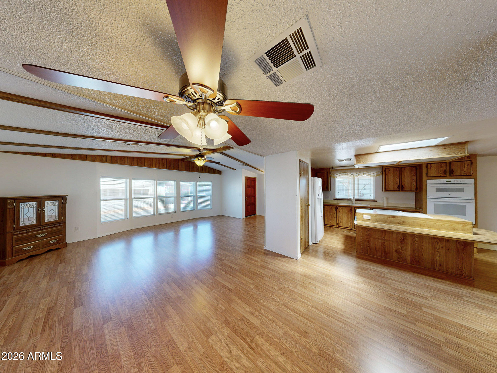 This VERY SPACIOUS HOME ! Is BEAUTIFUL! with A HUGE STORAGE ROOM  that could be used for many hobbies or Craft workshop! with a closed In Arizona Room/Enclosed Patio. Also a BUILT IN BAR! to entertain guests. Corner Lot, Vaulted Ceilings, and Large Kitchen! Located In a 55+Gated Community. Come see this well maintained home!