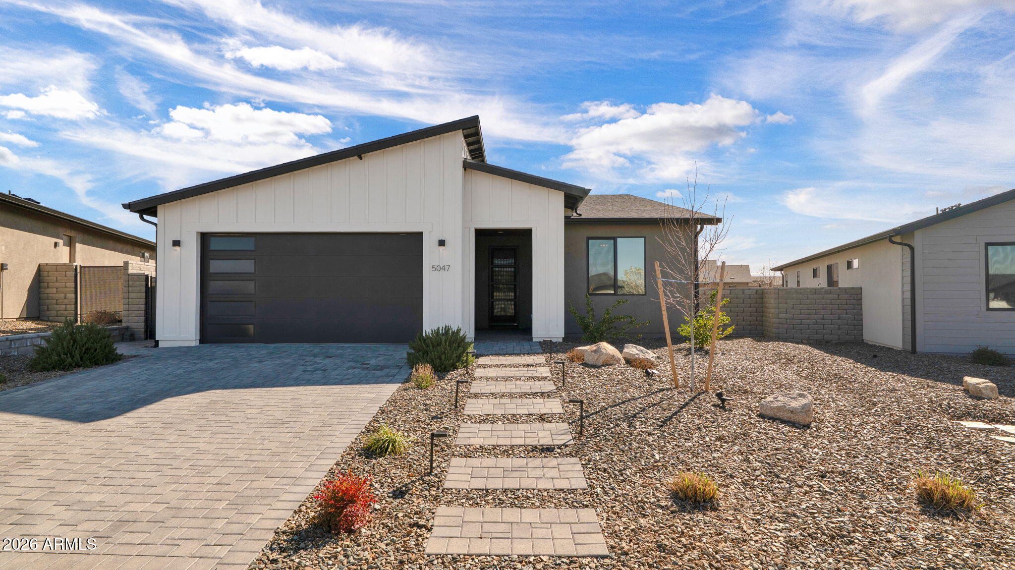 Start enjoying Jasper now. Located in the sought-after J Seven neighborhood, this home offers one of the advantages buyers appreciate most...the work is already done. While many nearby homes are still under construction, this property delivers a finished lifestyle from day one, with a thoughtfully completed backyard featuring a pergola, shade, landscaping, and inviting outdoor living spaces designed for Northern Arizona evenings. Inside, the efficient 3 bedroom, 2 bath layout offers 1,810 square feet of clean, current design that feels comfortable and easy to live in whether you're searching for a full-time residence or a lock-and-leave second home. J Seven is also the only section of Jasper where membership to The Jasper Club is optional, offering added flexibility buyers will appreciate. Thoughtfully designed for comfort and efficiency...this home blends modern design with energy-efficient construction and durable finishes. Inside, 9-foot ceilings and 8-foot doors create an open feel, complemented by luxury vinyl plank flooring throughout and quartz countertops throughout the kitchen and baths. The kitchen features 36-inch upper cabinets, stainless steel appliances, recessed lighting, under cabinet lighting an undermount dual-basin sink. Bathrooms include executive-height vanities, quartz surfaces, and a tiled primary shower with a clear glass enclosure. Energy efficiency is a standout feature of this home, built to Department of Energy Zero Energy Ready standards with spray foam insulation, an ERV fresh-air ventilation system, a 15-SEER heat pump, and Energy Star appliances. Outside, the home's modern exterior includes stucco and LP siding accents, black Low-E windows, an 8-foot glass-panel entry door, and paver driveways and walkways. The property also features block privacy fencing, low-maintenance landscaping, and a Wi-Fi-enabled garage door opener.