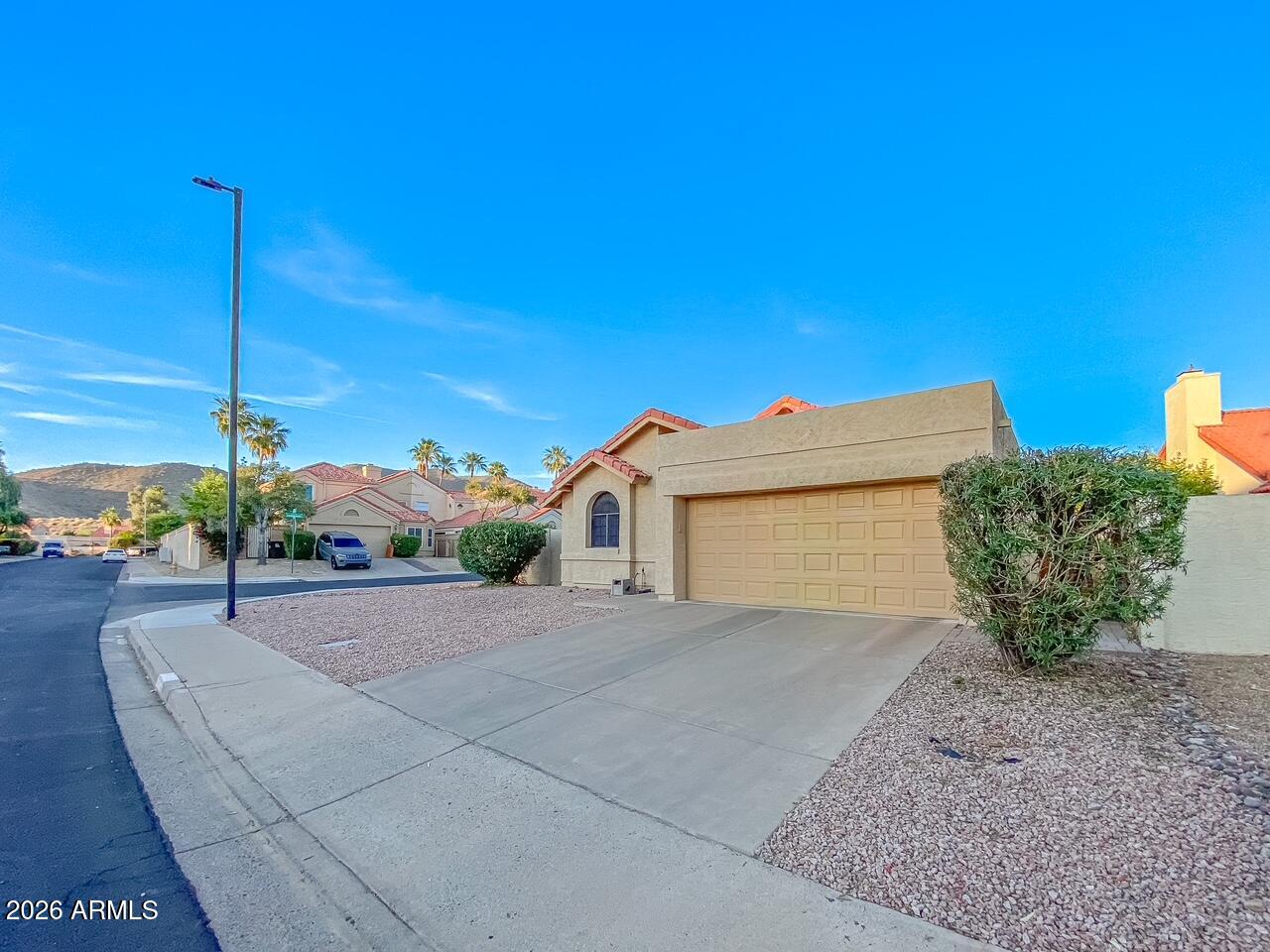 An affordable North Scottsdale home in a quiet and safe neighborhood! Shows beautifully. Located in the Casa Norte community on a desirable corner lot. This 2-bedroom, 2-bath, 1,441 square foot home has a wood fireplace, rare RV gate, and 2-car attached garage ideal for desert toy storage. Recently updated backyard with covered patio for quiet evenings. Extremely clean inside and out (no pets, no smoking), and replaced roof (2021) make this one move-in ready