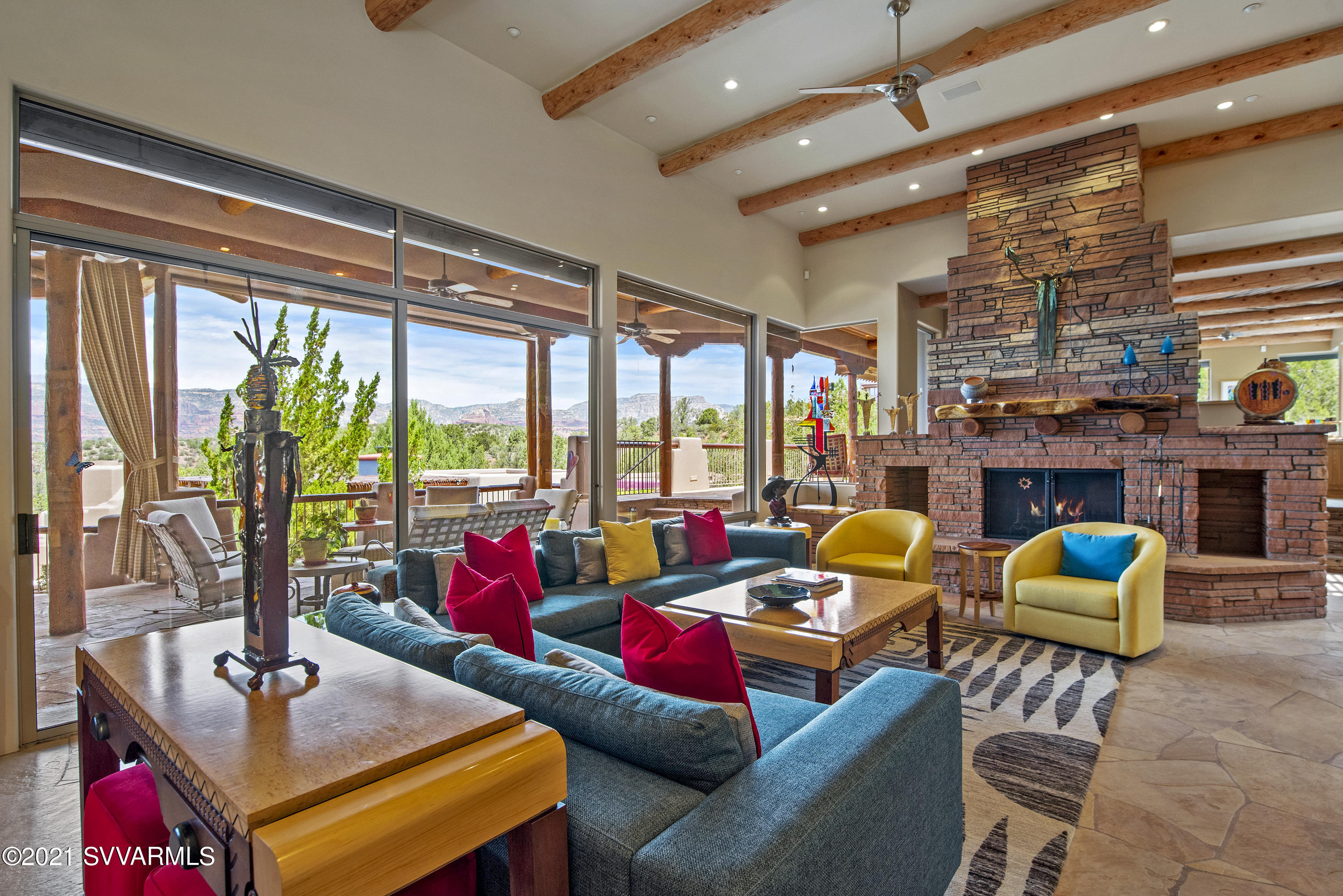Come home to your own personal paradise! This extraordinary family home, in exclusive and gated North Slopes, is one of Sedona's most distinctive and luxurious estates.  And, it comes turn-key! The price includes nearly all of the custom furnishings including thousands of dollars worth of precious artwork. Friends and family will share your delight in this timeless Contemporary Southwest residence. Surrounded by paths & gardens and bordering U. S. National Forest, this magical property has everything you could want in a luxury home. No detail has been overlooked in the Arrow B residence, designed by Carl Nelson and constructed by renowned builder, Randy Toogood. From the opulent built-in furniture to the dichroic glass cabinets to the latilla ceilings and accents. (pls click 'More') The attention to detail is unsurpassed. The front courtyard with its lush garden and water feature sets the stage for what's to come. Enter through the custom stained glass front doors and be welcomed by the jaw-dropping red rock panorama. The exquisitely designed open floorplan creates an indoor-outdoor flow that brings nature home and the home to nature.  The organic architectural style, hints of Frank Lloyd Wright, takes full-advantage of Sedona's mild four seasonal opportunities for outdoor living. A cool, shaded patio, spanning the length of the home, overlooks the infinity pool and miles of forest and red rocks. Generous seating and dining enclaves surround a 60" grill and outdoor kitchen, making entertaining easy. Bronze sculptures and landscaping add to the outdoor ambiance. The property abounds with indigenous plants, cactus and junipers, some of which are over a hundred years old. The astonishing main level comprises the sumptuous Master Suite, Chef's perfect-for-entertaining Dream Kitchen, elegant Dining Room, lavish yet comfortable Living Room, splendid Media Room/Library, the World's Best Office with marvelous 270 degree views of Lizard Head, Thunder Mountain, Doe and Bear Mountain. The two work stations are perfect for remote executives. The center island and built-in cabinets with slide-out-shelves provide plenty of storage. The full-sized sunken bar in the living room, with customized etched glassware, is first class and features a built-in wine fridge, icemaker, dishwasher and refrigerator. Serious cooks truly love the professional-grade Kitchen, featuring three Dacor convection ovens, 48" Subzero fridge, a 6 burner gas range and two Asko dishwashers. Tons of kitchen storage in addition to the walk-in pantry.  
Downstairs, family and friends are embraced by two Guest Suites, each with its own patio, a Media-Living Room and fine Wine Cellar.  Beyond that is the fabulous, spacious, and well-appointed, stand-alone Guest Casita. Furnished with a living room/kitchen, jacuzzi and washer/dryer, it exudes a wild west feel your guests will love. In yet another building is the state-of-the-art Fitness Center with a ¾ bathroom, floor to ceiling window, mirrored wall, and rainfall shower.
 Close by is the magnificent infinity pool and spa replete with waterfalls and red rock views. After chilling in the pool, guests can shower and change in the cabana, just steps away. Listen to music and enjoy cocktails on the rooftop deck with dazzling 360 degree views - perfect for taking in spectacular Sedona sunsets or stargazing. Downstairs there's a generous basement for storage and a Game Room (aka, Man Cave) with a pool/ping pong table and professional card table. This magnificent and meticulously maintained home is ideally located in West Sedona, minutes from shopping, hiking, restaurants, theaters, and wonderful arts, film, and music festivals. You won't find another like it!