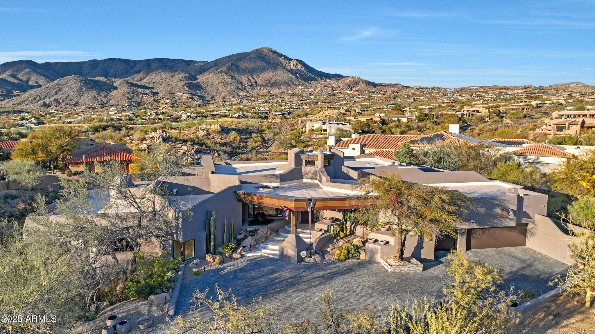 The ultimate Scottsdale luxury home in prestigious Desert Mountain, a premier guard-gated golf community. FULL GOLF MEMBERSHIP AVAILABLE. This fully renovated 5,106sf estate blends organic Tulum-style design with modern elegance. Featuring 4 bedrooms, 3.5 baths, and open-concept living with floor-to-ceiling glass wall showcasing gorgeous mountain views. The designer kitchen offers top-of-the-line appliances and a waterfall-edge island. Enjoy new micro-cement floors, wood beams, and three indoor stone fireplaces. Outdoor living shines with a remodeled negative-edge heated pool, spa, stone fireplace, outdoor kitchen, and expansive new deck. Surrounded by seven Jack Nicklaus Signature golf courses, fine dining, spa, fitness, and private trails—AZ golf living at its finest!