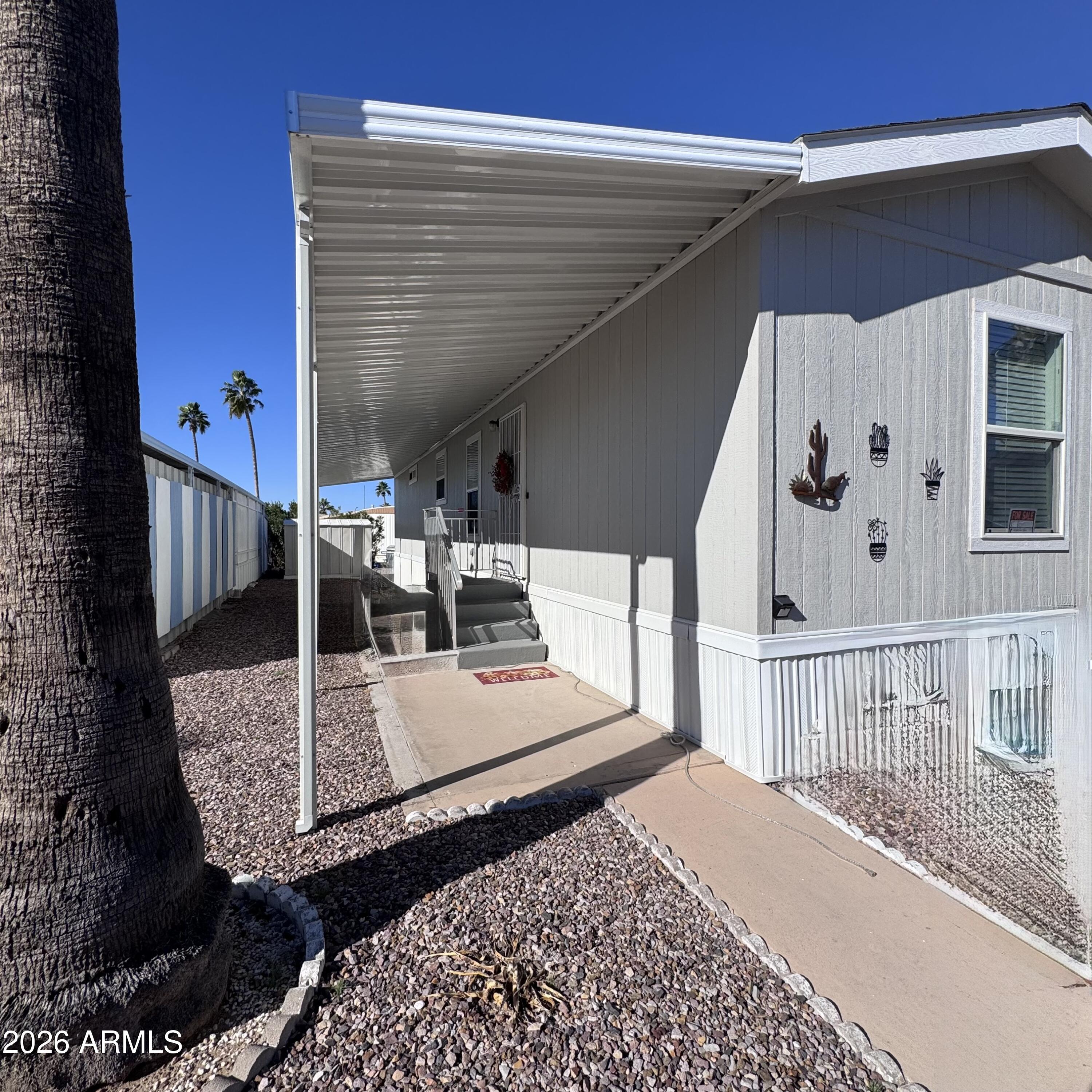 Built in 2019, this beautifully updated unit truly feels like a home away from home. A thoughtfully added extension creates a spacious, airy layout with generous natural light throughout. Enjoy high, covered patios on both sides of the home—perfect for relaxing or entertaining year-round.
The newer HVAC system ensures comfort in every season. Inside, you'll find a large family room, generously sized bedrooms, and a spacious kitchen featuring ample cabinetry and storage.
Additional highlights include a backyard storage shed, covered parking, a water softener, and a reverse-osmosis drinking water system. The functional floor plan offers flexibility for full-time living or a seasonal retreat. Ideally located in Apache Junction with convenient access to shopping, dining, and abundant outdoor recreation, including the stunning nearby Superstition Mountains.
Rosehaven Estates is a well-maintained 55+ community known for its relaxed lifestyle and easy access to major roadways. This move-in-ready home is perfect for buyers seeking comfort, affordability, and low-maintenance living.