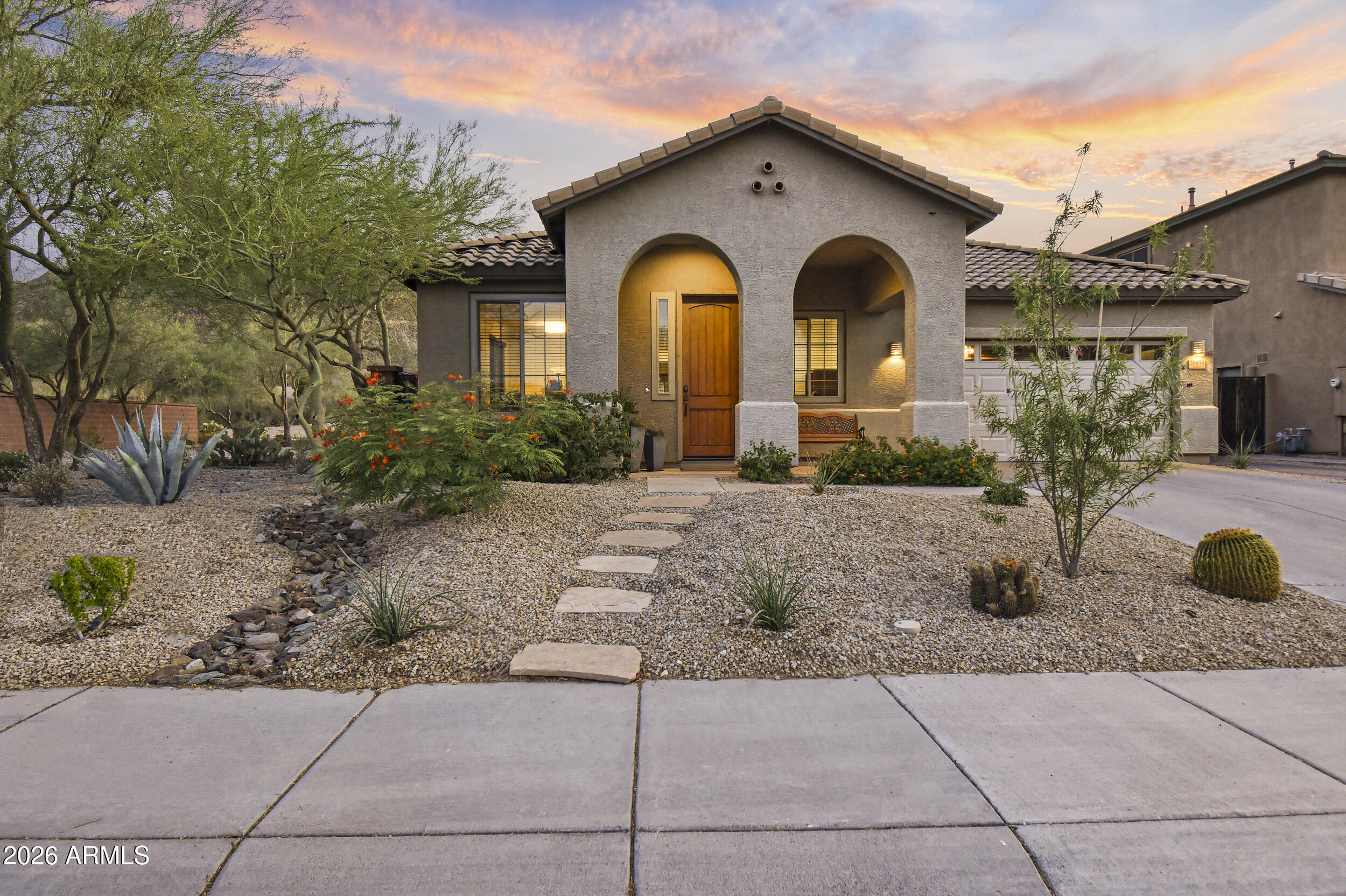 Experience the coveted WestWing lifestyle in this beautifully appointed home, where an airy open-concept design, abundant natural light, and a desirable split-primary layout create the perfect home. Designed for both everyday living and memorable entertaining, the backyard is a private retreat featuring a large play pool, sweeping mountain and sunset views, a covered patio with a built-in BBQ area, lush turf-all complemented by an enlarged RV gate with pavers for additional parking and a two-car garage with built-in cabinetry. Inside, the spacious primary offers French doors opening to the patio and a generous bath with dual sinks and a private water closet. The well-equipped kitchen showcases 42'' Cherry cabinets, a large granite peninsula, and built-in appliances flowing into the breakfast and family room spaces. A large office with an exterior-facing window and French doors to the great room adds versatility and style. You are within walking distance of parks, walking trails, an A+ K-8 school, a fantastic church and exceptional shopping and dining just minutes away. New HVAC 2022, new carpet & paint 2026, new Irr. valves with pvc piping, new garage door.