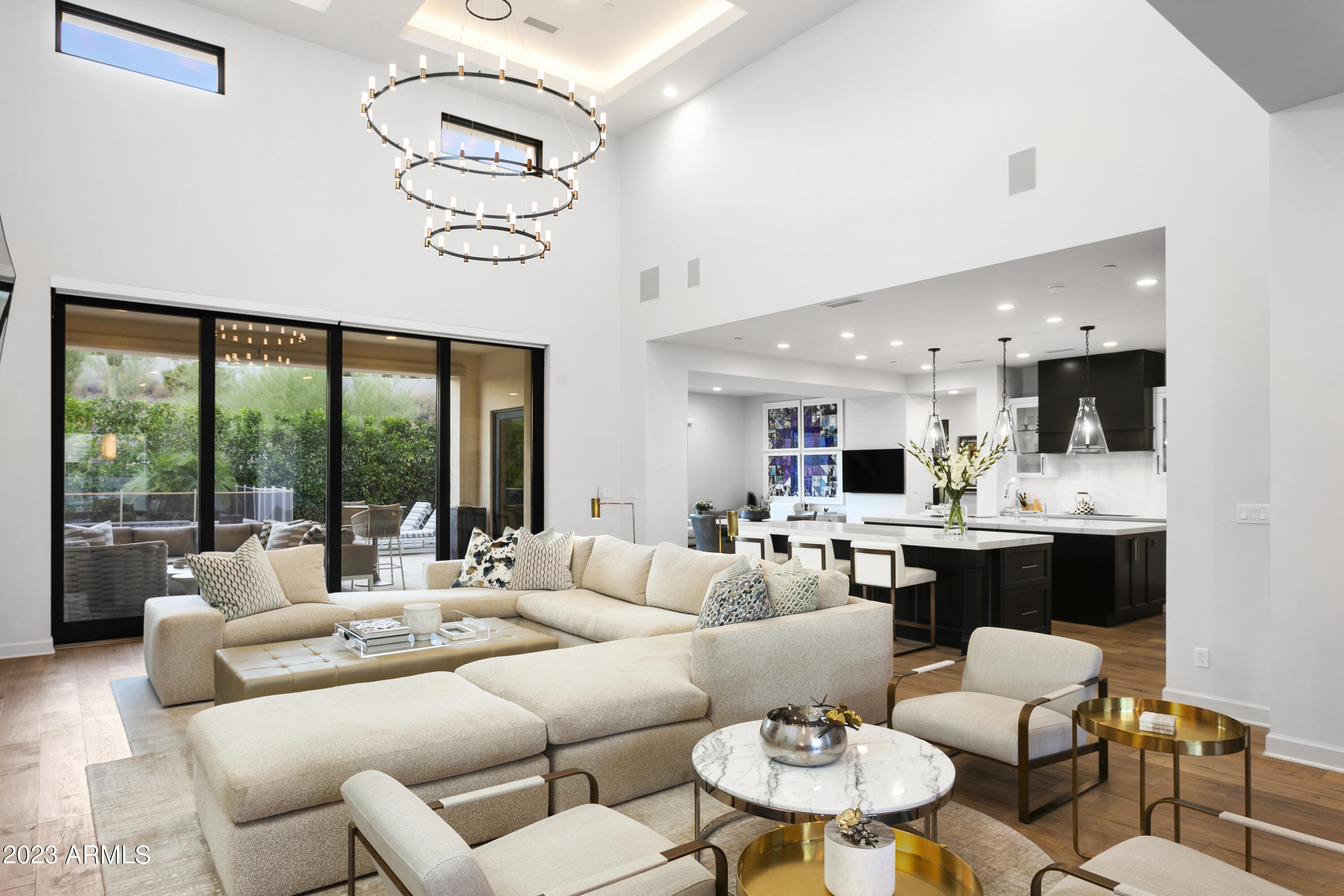 This well-appointed home, nestled within the exclusive gated Village at Paradise Reserve community, is a harmonious blend of modern elegance and architectural charm, creating a timeless home that will captivate you. Soaring ceilings and seamless living spaces lead to an expansive covered patio and meticulously landscaped backyard oasis with a pool and spa. Top-of-the-line finishes throughout the entire home provide elegance and comfort including the warmth of Du Chateau European oak floors, Sub Zero appliances, a generous kitchen island, marble countertops, and a floor-to-ceiling fireplace. As you relax in this serene setting, you'll be treated to panoramic views that include picturesque mountain preserves and city light, complete the package of this exceptional home.