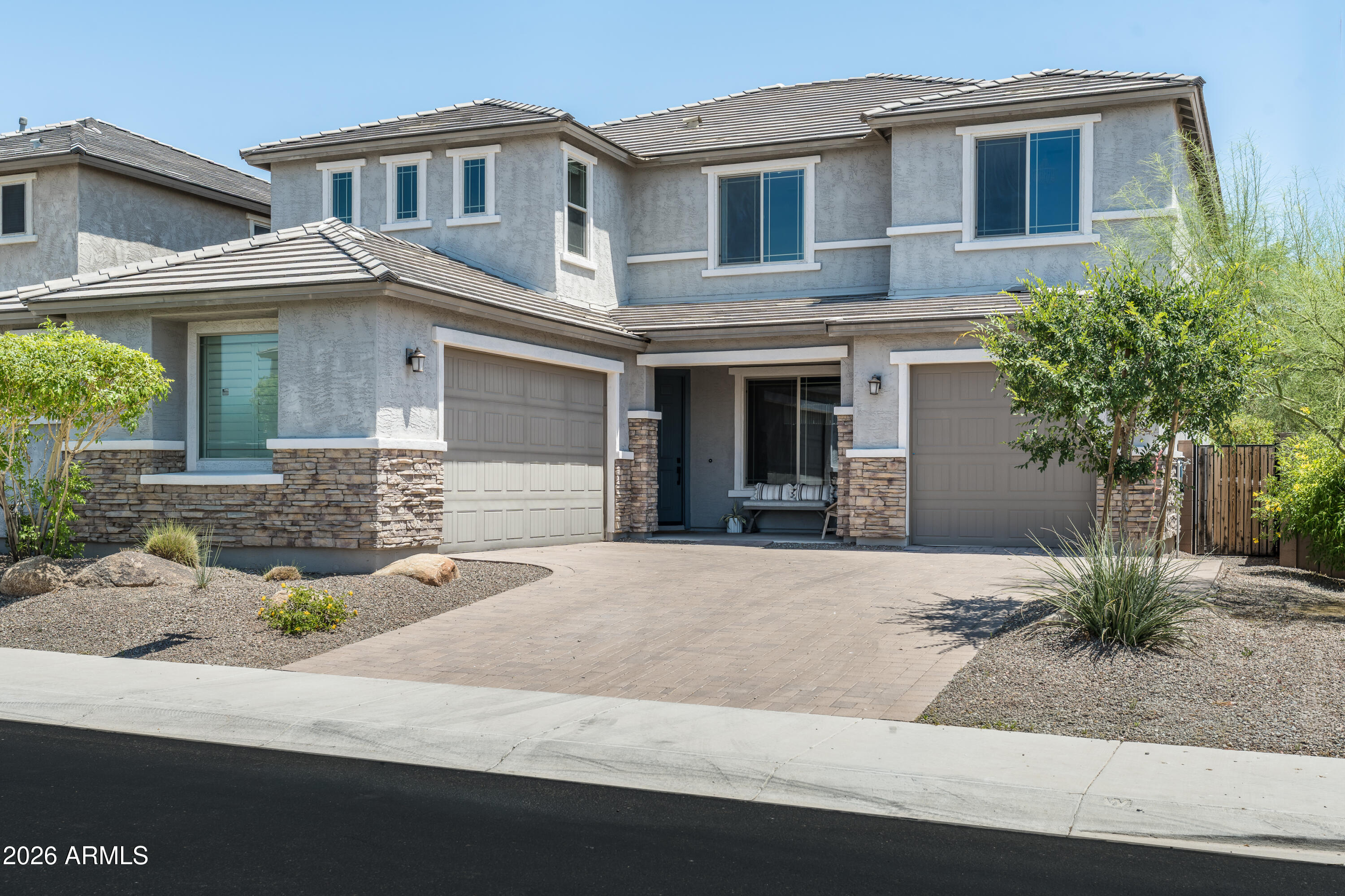 Stunning 2021 Starwood by Pulte in Aloravita -- $175,748 in Upgrades + Premium View Lot
Tucked into one of Peoria's most coveted enclaves, this designer-finished home backs to open space with no rear neighbors and spectacular mountain views. The chef's kitchen anchors the great room with a striking granite oversized island, matte black fixtures, walk-in pantry, tile backsplash, and a crystal chandelier above the eat-in nook. Modern sliders open to a covered paved patio and lush, low-maintenance yard. A custom-tiled fireplace, formal dining, and sleek modern tile flooring elevate every space. The main-level guest suite features a walk-in closet, tiled shower, and granite counters. Upstairs, a spacious family lounge and luxe primary retreat with dual vanities, soaking tub, and oversize walk-in closet await. Executive office (optional 5th bed), dual built-in desks, designer laundry, multi-room in-ceiling speakers, and oversized 3-car insulated garage round out the home. Zoned to strong Peoria Unified schools (Liberty High, Sunrise Mountain) with top-ranked charters BASIS Peoria and Great Hearts Glendale Prep nearby.