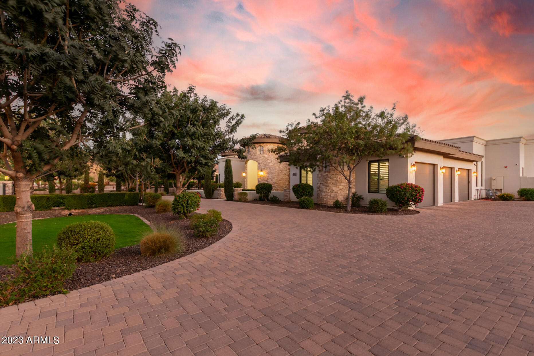 Private Gated Estate: A Luxurious Retreat
Nestled on a sprawling over 1-acre lot, sits a private gated estate that embodies grandeur and sophistication. From the moment you arrive, you are greeted with the impressive circular paver driveway that leads to a stately stone facade. This exquisite property offers not only a 3-car garage but also a Casita and DOUBLE RV GARAGE, 37x 52 with 16ft high ceiling, completed with air conditioning, giving you the flexibility to store your classic cars, RVs, or even transform it into an indoor/outdoor wedding venue or a magnificent man cave.
As you enter the estate, the expansive great room immediately captures your attention. With soaring high ceilings, modern recessed lighting, elegant plantation shutters, and rich wood flooring, A cozy fireplace adds a touch of warmth and charm, perfect for those cold evenings spent with loved ones.

The gourmet kitchen is truly a dream for every home chef. It features a charming breakfast nook, luxurious granite countertops, stylish pendant lighting, and custom cabinetry that blends both elegance and functionality seamlessly. Whether you are enjoying a casual meal or preparing a lavish feast, this kitchen will undoubtedly exceed your expectations.

The main bedroom is a serene retreat that offers a peaceful escape from the outside world. Flooded with natural light, it creates a tranquil ambiance that promotes relaxation. With a second warming fireplace, a spacious walk-in closet, direct backyard access, and an ensuite designed to pamper, this bedroom epitomizes luxury. Dual vanities, a lavish raindrop shower, and a sumptuous soaking tub are just a few of the indulgent features that await you.
For guests or multigenerational living, a beautifully appointed casita provides a comfortable space to retreat. Complete with a mini-kitchen, a cozy living area, and a full bathroom, this separate living quarters offer privacy and convenience.

Stepping into the backyard is like entering a private oasis. An outdoor paradise awaits, featuring a built-in barbecue, an inviting outdoor fireplace, and luxurious travertine floors. With unmatched views and ample space, this backyard is the perfect setting for weddings, social events, or simply relaxing in the Arizona sun. The sparkling pool takes center stage, providing a refreshing respite on warm days. Surrounded by natural landscaping, this outdoor sanctuary offers the perfect backdrop to savor breathtaking Arizona sunsets.

Additional highlights of this extraordinary estate include a detached RV garage, ideal for travel enthusiasts seeking to store their recreational vehicles securely. For ultimate relaxation, a rejuvenating spa and pool complete the luxurious amenities of this property.

In conclusion, this private gated estate represents the epitome of luxury living. From its circular paver driveway to its stately stone facade, every detail of this exquisite property has been carefully designed to exude grandeur. Whether you are seeking a tranquil retreat, a space to entertain guests, or a haven for your prized possessions, this estate offers it all. Embrace the lifestyle you deserve and make this private gated estate your own.