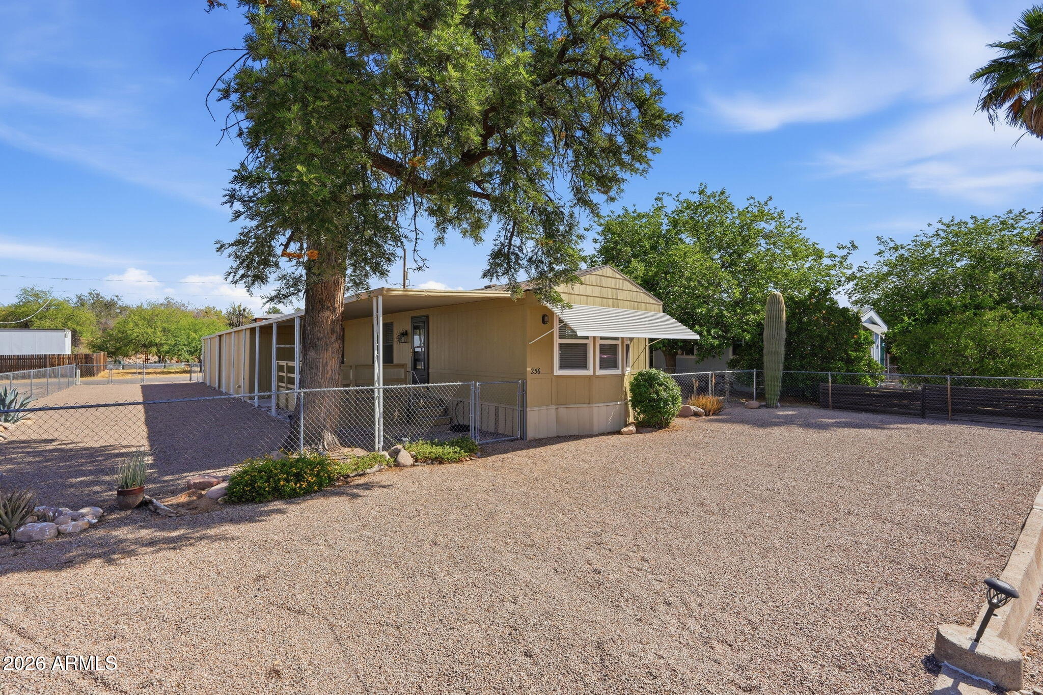 Charming single-wide on a 16x120 lot with no HOA in Queen Valley! This 2-bedroom, 1-bath home features vaulted ceilings and a cozy feel throughout. The beautiful kitchen includes all appliances, a bay window, and ample cabinet space. Bathroom offers a large soaking tub plus washer and dryer. Furnishings can convey if desired, making this a move-in-ready opportunity. Enjoy outdoor living on the spacious covered front porch and low-maintenance landscaping. Property also includes two storage rooms and a large garage/shop with convenient alley access--perfect for hobbies or extra storage!