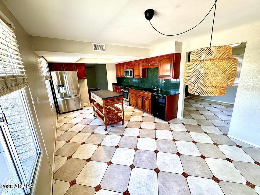 You will love the location of this 3 bed, 2 bath home in Northeast Phoenix. The large remodeled kitchen has GRANITE countertops & Cherrywood cabinets and also newer appliances, including a Washer & dryer.  The flooring has both Pergo & 16 inch tile throughout. The Primary bedroom has an ENSUITE bathroom and the guest bath features- DOUBLE sinks, tub/shower & Travertine tile.  Newer roof and exterior paint. 5 year old HVAC. HUGE backyard, North/South exposure. Roadrunner park just steps away, close to 51 freeway, GREAT Paradise Valley school district!
