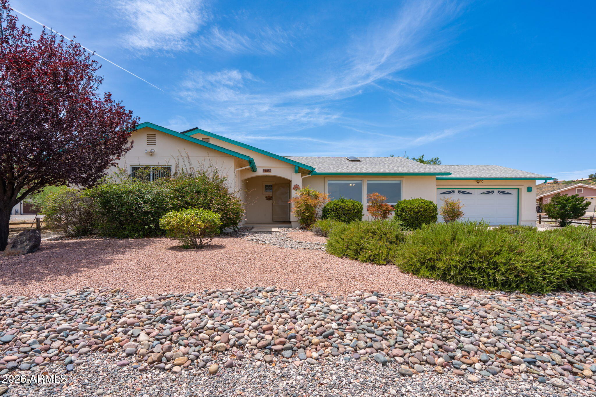 Red Rock views of Sedona from the front of the home create an immediate sense of calm and openness. Large front windows bring those views into the main living area, where vaulted ceilings, skylights, and natural light give the home a bright, comfortable feel. Set on a nearly half-acre lot with mature landscaping and low-maintenance hardscaping, the property offers space, trees, and an easy-care exterior that feels different from a standard subdivision lot. Inside, the home feels solid, clean, and well maintained, with generous living space, a large primary suite, comfortable secondary rooms, and a screened Arizona room. Prepaid leased solar is already in place, adding a meaningful ownership benefit while the home offers room to update over time.