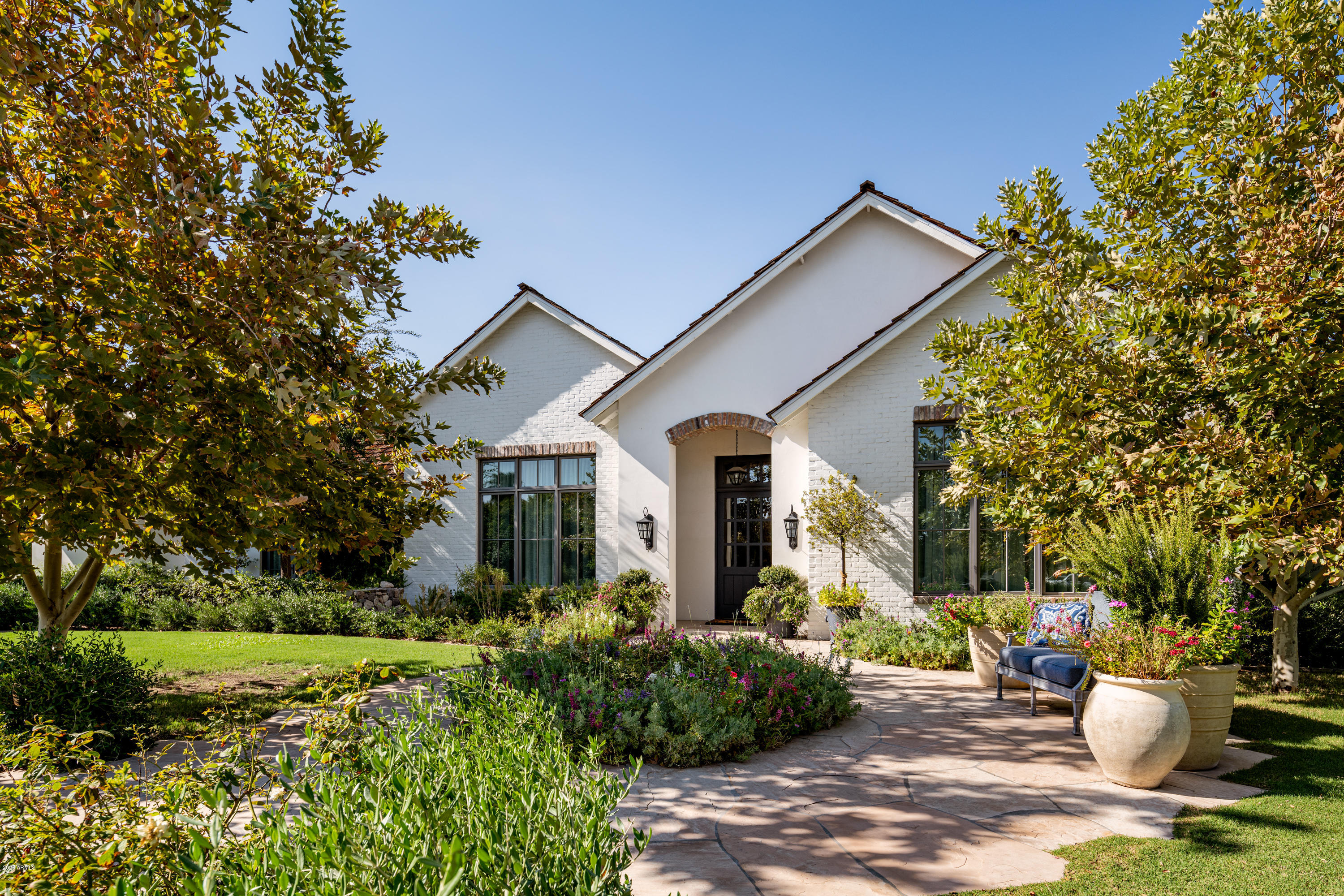 If high style, unparalleled quality, inspiring design and exceptional taste top the list of what you're looking for in a home, look no further because this impeccable residence has all of that and more. Sitting on a spectacular lot, not a detail was overlooked inside or out. The beautiful island kitchen has shaker cabinetry, top of the line appliances, an artistic custom backsplash, and a designer plated hooded range that serves as a dramatic focal point to the space. The spacious great room has extensive custom cabinetry and an exposed brick fireplace, and the ultra chic dining room has an adjacent wet bar offering a perfect serving spot. There's a climate controlled wine room, an exquisite one of a kind library, and a spectacular master hideaway with a sleek master bath, and a brand new master closet that is quite simply, over the top. Lovely wallpaper and brand new lighting compliment the outstanding design, adding another layer of unique inspiration. The entertaining options are endless with a thirty speaker sound system, and there's an impressive separate structure with a built in sauna and steam room with commercial grade equipment, and its own air conditioning unit. Just outside that are separate cold and hot plunge pools with glass tile and lush landscape providing ultimate privacy. The entire front, back and side yards were completely leveled to create an environment that is truly one of a kind and every detail was considered from the zero edge pool and spa, to the outdoor kitchen with with a large burner 48 inch grill, farmhouse sink, refrigerator, ice maker and smoker. The conversation fire pit, gazebo, covered and uncovered patios and magnificent mountain views accentuate the incredible backdrop. This home has character rarely seen or duplicated, and the combination of design expression, comfort and livability give it a very special flair!