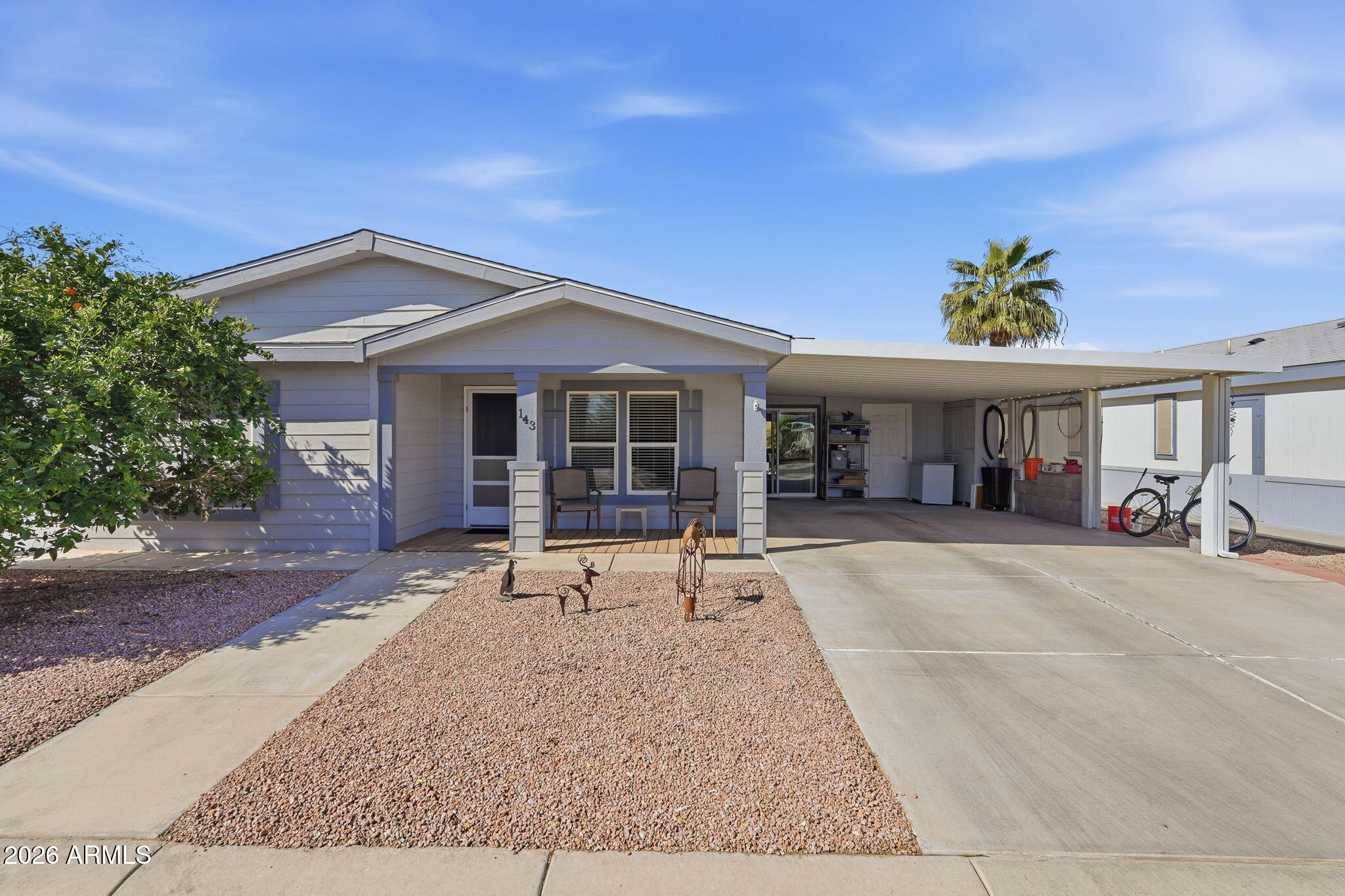 Welcome home to this charming corner-lot retreat where comfort, character, and community come together. A mature orange tree graces the front yard, offering natural shade over the inviting front porch which is the perfect place to enjoy your morning coffee, wave to neighbors, and truly feel at home.  Step inside and you'll immediately appreciate the vaulted ceilings that create an open, airy feel throughout the main living spaces. The spacious great room seamlessly blends the living and dining areas, making it ideal for entertaining friends or enjoying peaceful evenings at home.  You'll find two generously sized bedrooms and two full bathrooms, both featuring double vanities for added convenience and functionality. Ceiling fans in the bedrooms and great room enhance comfort year-round The kitchen offers an eat-in dining space along with a built-in desk and additional cabinetry for storage...perfect for staying organized, managing household details, or working on hobbies while staying connected to the heart of the home.  From the two-car carport, step into the enclosed patio, a cozy extension of the home that invites you to curl up with a book, host neighbors for game night, or simply relax in your own private retreat. The shed, currently used as a workshop, provides abundant storage and flexible workspace options.  Solar shades on the windows and roll down shades on the back patio.  Energy efficiency is already in place with solar panels there are 10 owned and 11 leased helping reduce utility costs. The recently replaced roof includes a transferable 30-year warranty, offering valuable peace of mind.  Located in an active 55+ community, residents enjoy an exceptional lifestyle with amenities including pickleball, shuffleboard, cornhole, a pool and spa, bowling, and so much more. Whether you're looking to stay active, socialize, or simply relax, this community offers something for everyone.  This is more than a home, it's a lifestyle designed for comfort, connection, and easy living.
