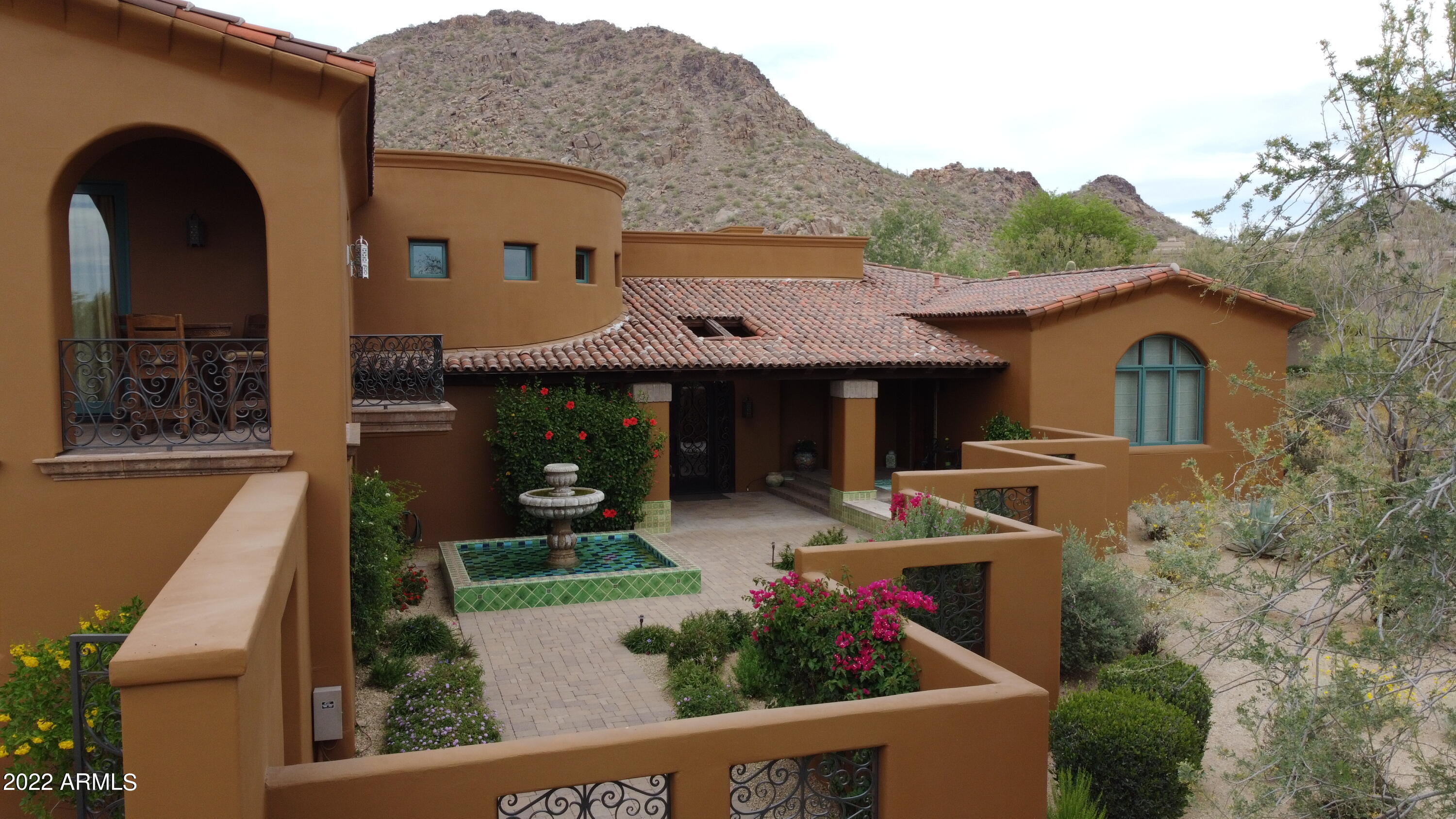Stunning Spanish inspired home offering quality construction and attention to detail throughout.  Gated courtyard entry with manicured landscaping and cascading water feature. Open and spacious great room with soaring ceiling and expansive windows and doors , extending onto the outdoor living terraces. 3 bedrooms including luxurious primary suite, guest bedroom with ensuite bath, detached 2-room guest house, private office/den, 3-car garage.  Chef's kitchen with top-of-the-line appliances and premium finishes.  Expansive covered patios, overlooking the 2nd fairway and mountains beyond,  includes outdoor dining with built-in barbecue, furnished outdoor living room, heated pool and spa. Desert Highlands, ranked as a top 100 club by Platinum Clubs of the World, offers world class amenities include a Jack Nicklaus championship golf course, 18-hole putting course, award winning clubhouse featuring Jack's Gastrupub and Jack's Backyard, bocce ball, Highlands Racquet Club offering grass and clay tennis courts + pickleball courts, state of the art fitness center & more. A $95,000 membership fee is due from buyer at close of escrow.
