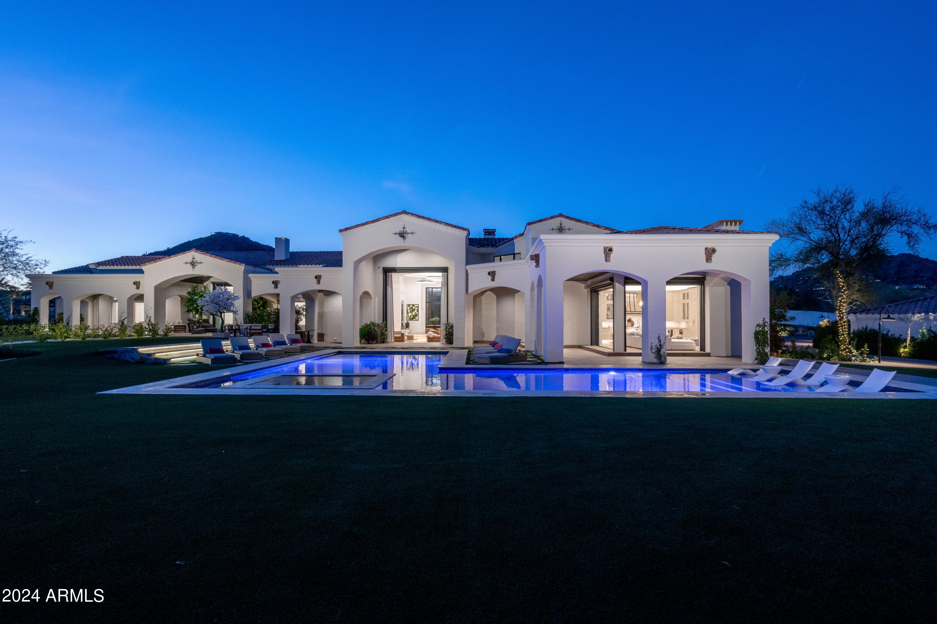 Welcome to this recently transformed, tastefully reimagined iconic Paradise Valley estate, redefining luxury living in Arizona's prestigious enclave. Opulence & elegance converge in a residence embodying Paradise Valley's essence, featuring timeless finishes & impeccable quality throughout. This trophy property is on an elevated 3.18 acres with unobstructed views of Camelback Mountain. A backyard oasis features a sparkling pool, spa, outdoor kitchen, cabana, & lounge area. This gated estate boasts 11,001 SF, 6 beds (full size laundry in every bedroom), 10 baths, private office, media room, gym options, sport court, bocce court, & a separate sanctuary amidst meticulously landscaped grounds. With an 11-car garage capacity, maintenance garage, & studio/office option, a car lover's dream!