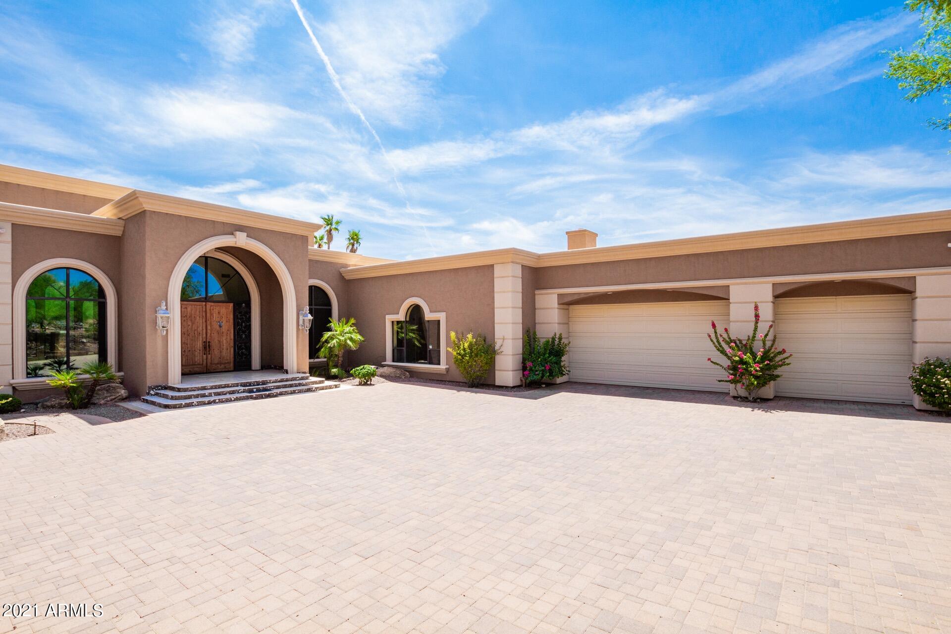 Wow! AMAZING Camelback Mountain estate w/impressive curb appeal & gated entryway. Enter the unique foyer & discover custom marble floors, ballroom-sized living room w/soaring coffered ceilings & stone fireplace. Huge formal dining w/custom ceiling design & exquisite chandelier. Spacious family room w/the multi-sliders merges the indoor/outdoor living. Magnificent kitchen features custom cabinets, gorgeous granite counters/backsplash, Wolf SS appliances, pull-out drawers, walk-in pantry, island, and breakfast nook w/delightful pool view. Upscale bathrooms! Main retreat boasts backyard access, fireplace, and a luxurious ensuite w/tub overlooking the backyard. Stunning backyard offers an outdoor kitchen, pool w/spa, and majestic mountain views. Words don't make it justice. Must see!