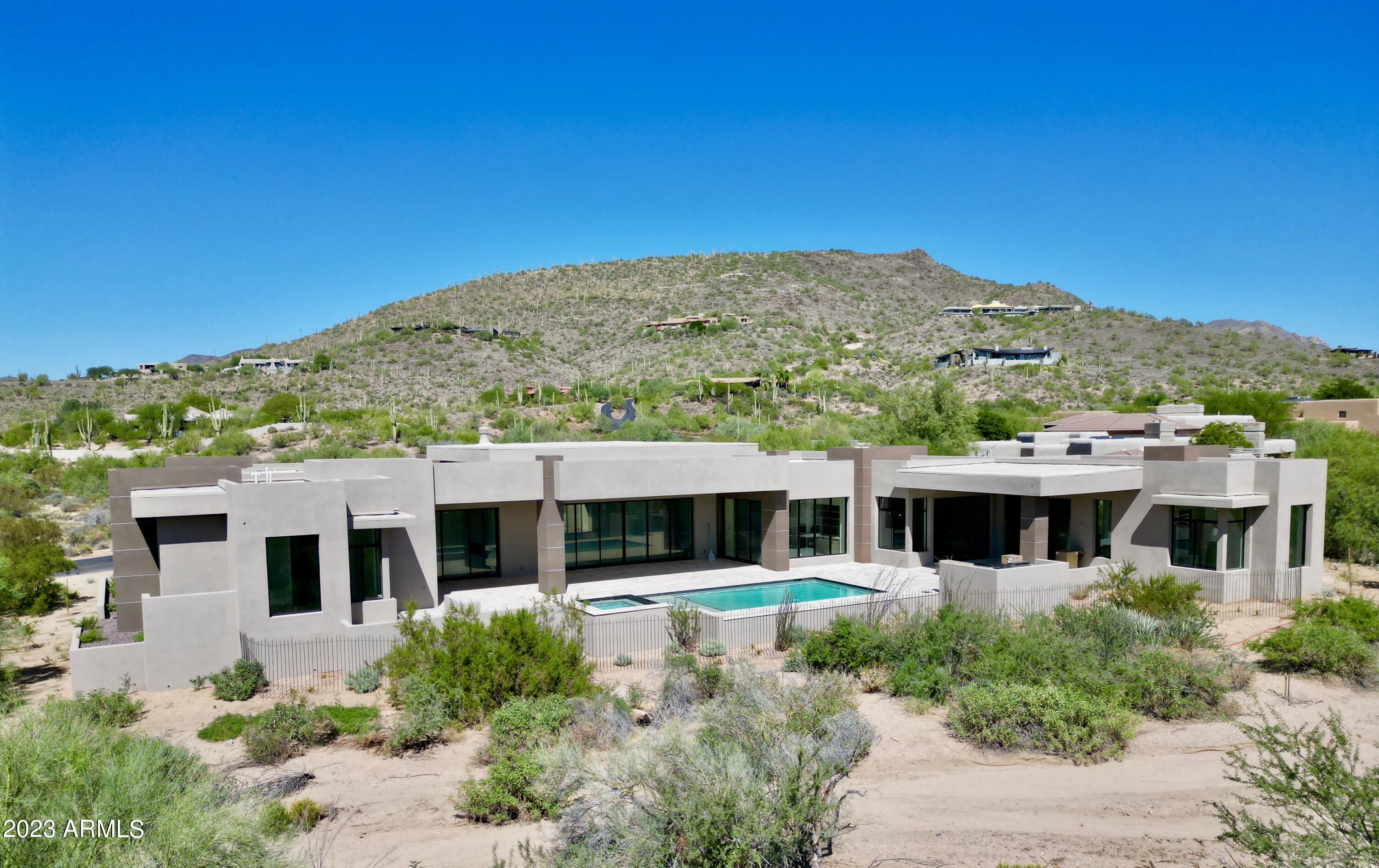 Welcome to our stunning new desert modern home located in the North portion of the Scottsdale desert, offering an unparalleled living experience. This 2023 masterpiece boasts an expansive design featuring several glass sliders that seamlessly blend indoor and outdoor spaces, inviting the breathtaking Arizona landscape indoors. 

Custom finishes adorn every corner, from the luxurious hardwood floors to the designer-selected fixtures that exude sophistication and elegance. The open floor plan highlights a spacious living area that perfectly complements the gourmet kitchen, equipped with top-of-the-line appliances and an expansive island, ideal for both family gatherings and entertaining guests. As you step outside, you'll discover an oasis in the desertenjoy the enchanting beauty of Arizona sunsets by the pool and spa, surrounded by meticulously landscaped gardens. This outdoor haven offers the perfect ambiance for relaxation or hosting exclusive events against the backdrop of the desert's natural beauty.

This property features a separate casita, adding versatility and privacy for guests or to serve as an office space. With 4 bedrooms and 5.5 bathrooms, each meticulously designed to reflect the utmost in comfort and style, the home caters to the desires of those seeking a serene desert lifestyle.

For the golf enthusiasts, the home offers captivating views of the prestigious golf courses in the vicinity, allowing you to revel in the picturesque landscapes right from your own private retreat.

The blend of modern architectural design, panoramic views, and luxurious amenities makes this home an exceptional opportunity for those looking to embrace the Scottsdale luxury lifestyle. If you're seeking the pinnacle of desert living, this home embodies the epitome of refined elegance in the heart of Scottsdale.
