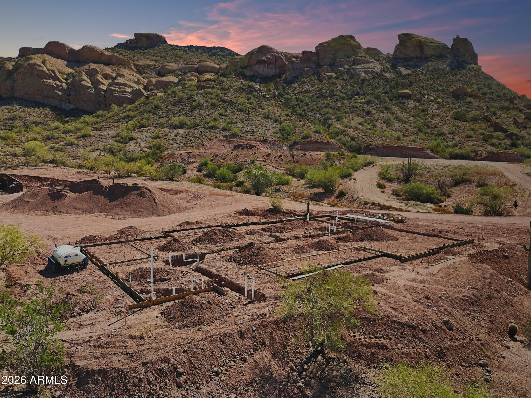 RARE FIND! Calling all Builders & Developers! 1.25 ACRE PARCEL - BUILD READY WITH CERTIFIED & ENGINEERED HOUSE PAD, PINAL COUNTY APPROVED BUILDING PLANS, PENDING SEPTIC PLANS, AND BASE PLUMBING INSTALLED! Project & Plans have APPRAISED AT $1,537,000. Seller will include Approved Building Plans & Permit with Sale. Form Boards are in - No concrete has been poured. Seller will include crushed granite on-site for landscaping. Property includes access to Shared Well. Home Plans are 3,435 sqft, 4 Bedrooms + Office/Den, 3.5 Bathrooms, 3-Car Garage, Covered Porch, Covered Patio, RV Garage, and 400amp Power. Land is BUILD READY with CONSTRUCTION STARTED!