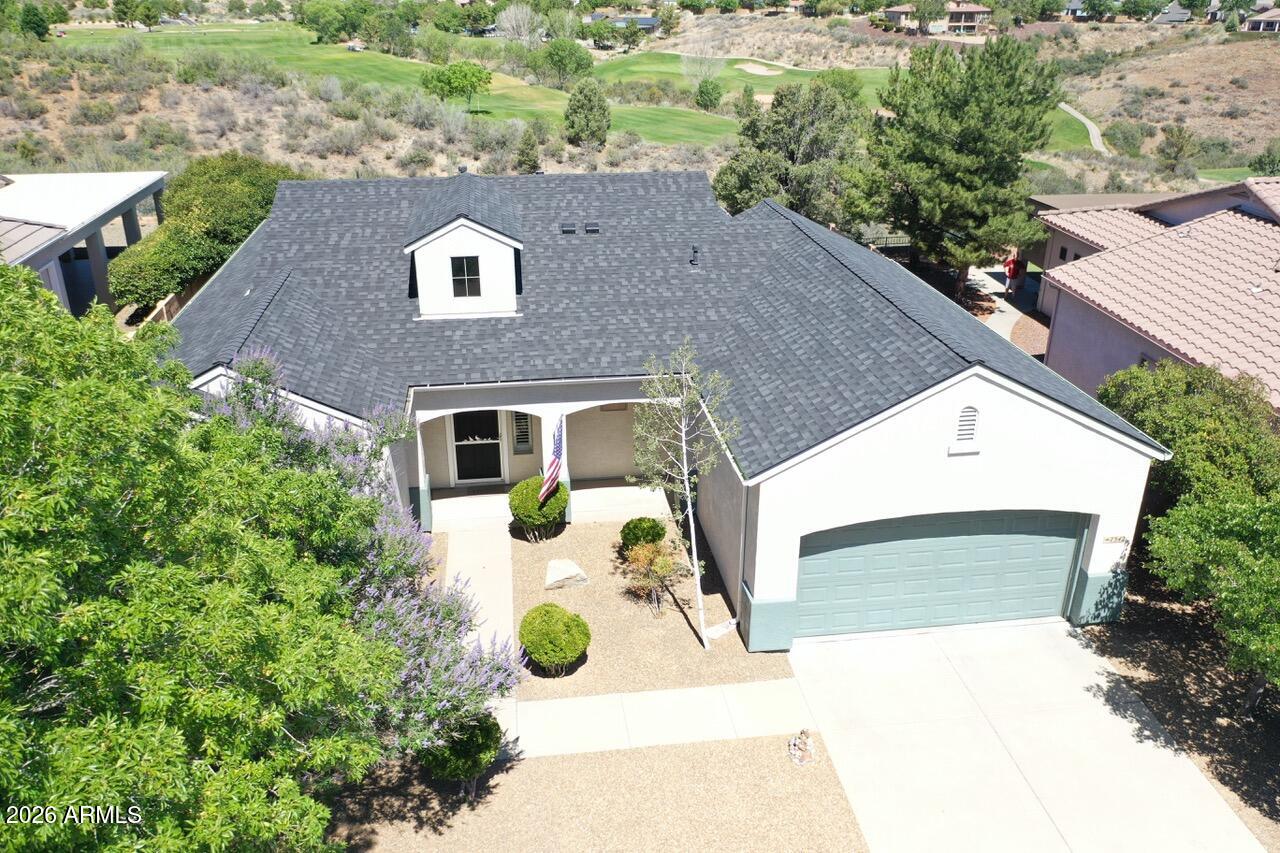 LOCATION, LOCATION! Welcome to Prescott Valley's premier master-planned community. If views, upgrades, and amenities are what you're after, this Stoneridge home fits the bill. Ideal as a primary residence near everything or a quiet second home, it's close to Phoenix and a short drive to Prescott. This turnkey home offers over 2,000 sq ft, currently 3 bedrooms and 2 baths, with a family room that can be converted into a 4th bedroom. It's a single-level retreat with extra garage space for a golf cart, classic car, or man cave. Features include quartzite countertops in the kitchen and baths, Blanco sink, and large entertaining island. It has a reverse osmosis water system, plantation shutters, energy-efficient cellular shades, porcelain wood-look tile floors, and a Prestige mesh screen door.