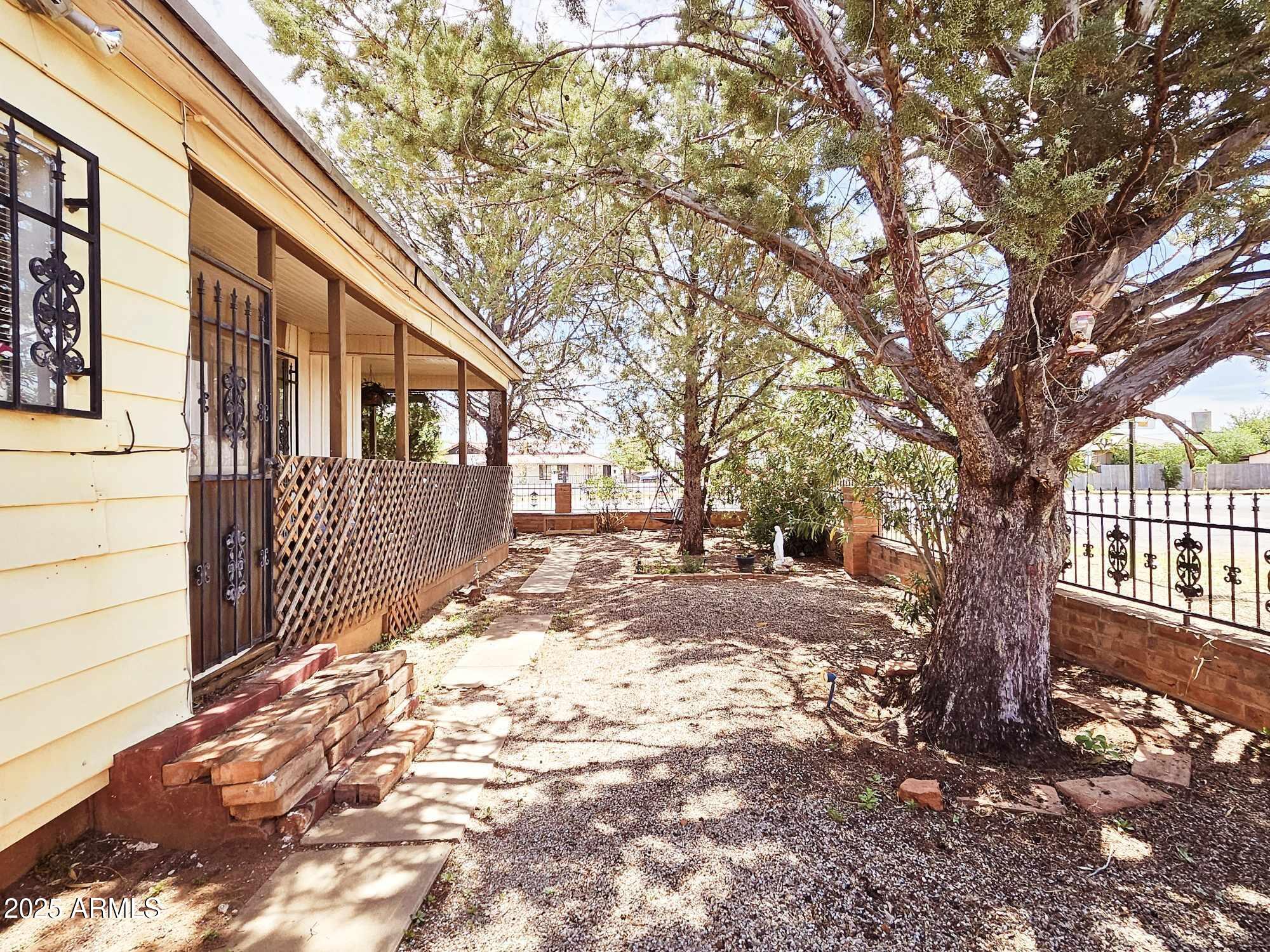 Discover the perfect balance of historic charm & comfort in this unique 3-bedroom, 2-bathroom home, nestled in the heart of Naco, Arizona. Ideally located for professionals commuting to Naco, Mexico, this property also offers excellent rental potential, making it a smart choice for both homeowners and investors. Step onto the expansive wraparound porch & enjoy peaceful mornings with coffee or relaxed evenings surrounded by the quiet ambiance of Naco. Inside, you'll find three spacious bedrooms & two bathrooms, split floor plan. The large block-walled yard, complete with mature trees, provides shade, privacy, & a safe space for children & pets to play. With its blend of character, convenience, and investment opportunity, this home is truly one-of-a-kind in Naco Arizona.