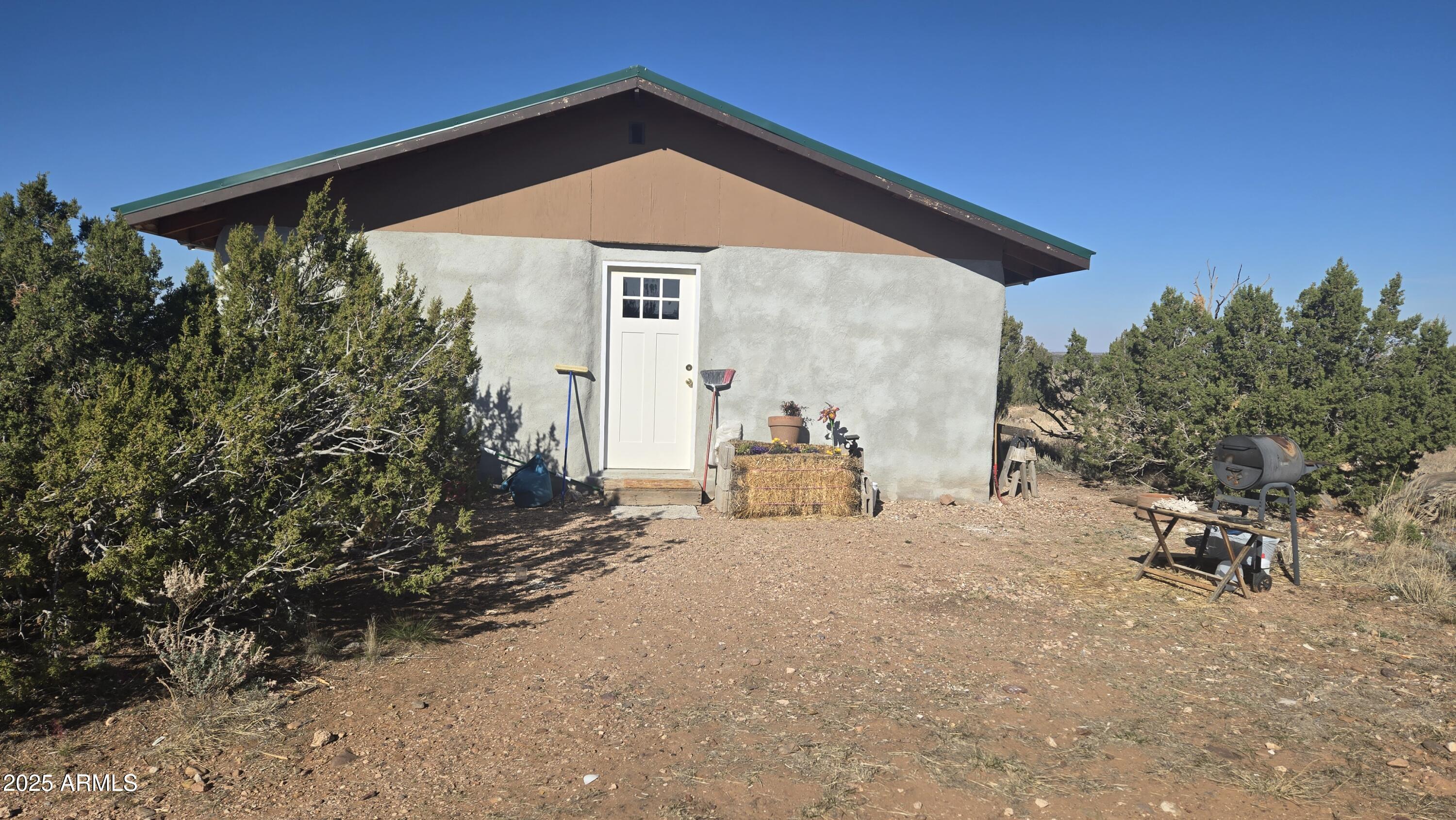 4 yrs old off grid home straw built with concrete foundation studs to line up 24inch straw walls and mini split Ac / heating unit. 4yrs old septic.  Hauled water and recruit pump into home, Solar owned, all electric, on 36 and 1/2 acres enjoy stars at night and quiet days. $300 HOA fee per year grades county roads, has trash bins for pick up and well to get hauled water without going into town.  Enjoy low tax on land and home no electric or water bills.  learn how to garden with straw.
