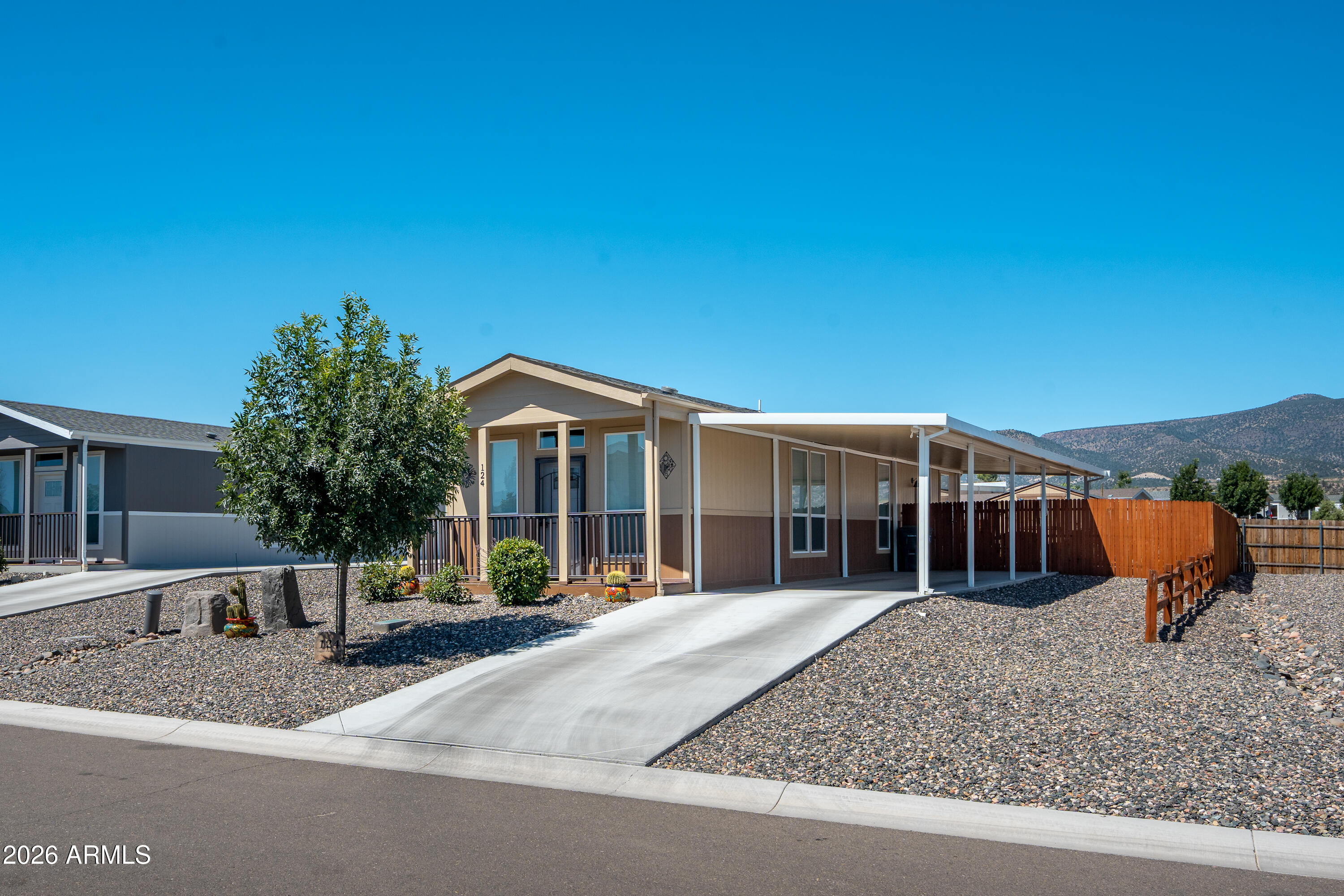 Welcome to Verde Ranch Estates, a gated all-ages community offering resort-style amenities and carefree living! This charming 2 bedroom, 2 bathroom home features 920 sq ft with an inviting open-concept layout, laminate flooring, abundant natural light, and a stylish kitchen with stainless steel appliances and a convenient island. The spacious primary suite provides comfort and privacy, while the stacked washer/dryer adds everyday convenience. Outside, enjoy mountain views from the covered patio, a fenced backyard with low-maintenance turf, storage shed, and covered carport. Residents enjoy an impressive clubhouse with a pool, hot tub, fitness center, BBQ pavilion, putting green, pickleball court, horseshoe pit, dog park, and more. Experience the best of Verde Valley living!