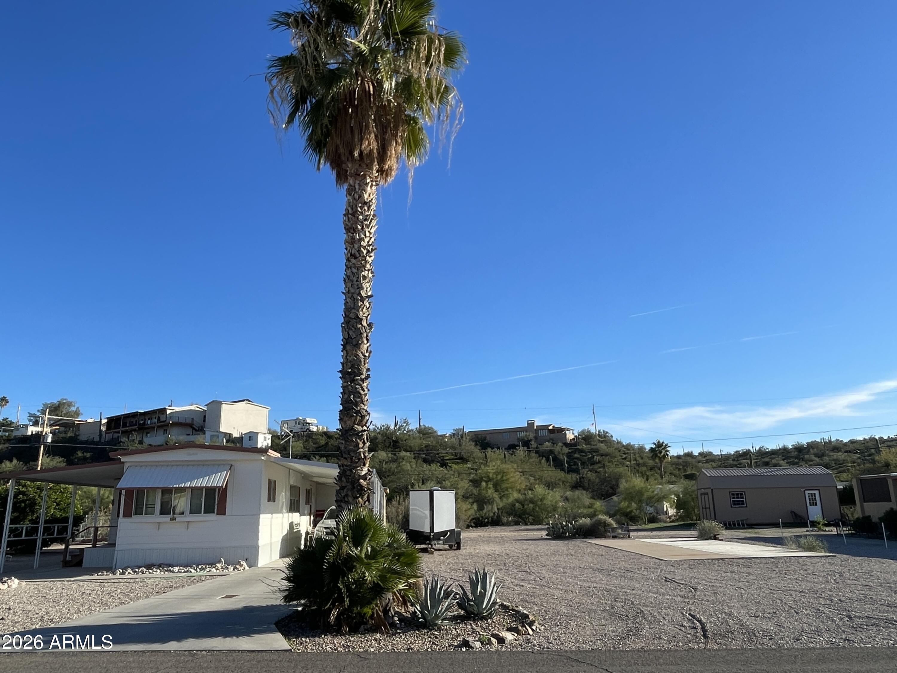 Two lots! This well maintained home comes with an additional lot that has a concrete pad, and its own septic ready for your RV parking, build a garage, shop, or split it off for revenue.  Enjoy being outside with fruit trees, a fenced off garden area, and room to create your own backyard oasis. The home is a two bedroom one bath with nice updates. The bathroom has newer flooring and counters. The kitchen has plenty of storage with lovely new cabinets, newer appliances and updated flooring that extends into the dining room. The laundry room is off the primary bedroom offering additional room for storage or a workshop. The garage is accessed from the back of the property with walk through door on the coverage front patio. The home is being sold furnished.