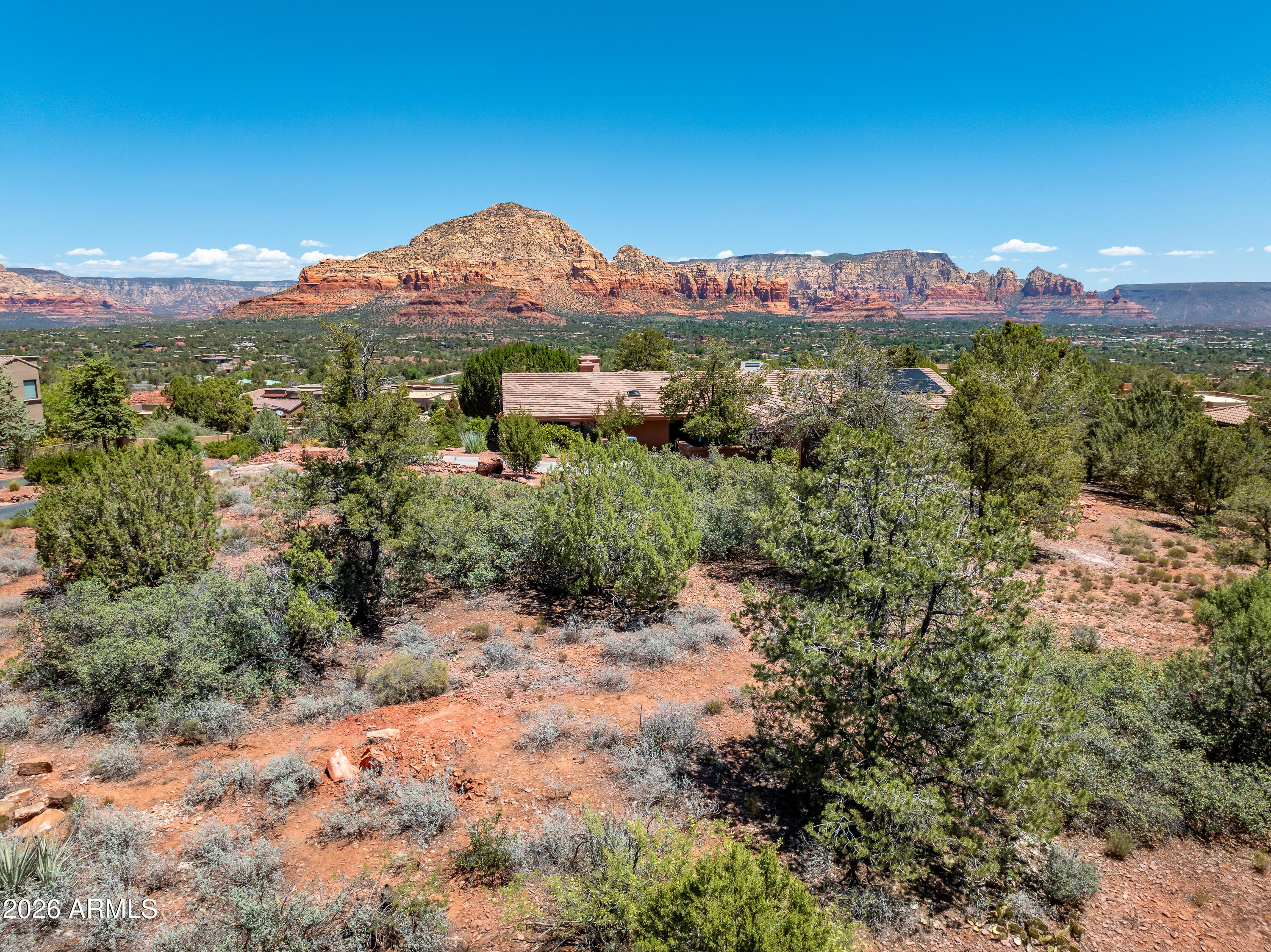 Surround yourself with Sedona's scenic beauty from this easy to build, flat, yet elevated lot with commanding views of the nearby red rocks. Gated community provides privacy and seclusion, and this oversized lot offers a new owner a perfect opportunity to build a dream house with Sedona's best views in a quiet location. Sited towards the top of the hill, this elevated lot has all utilities underground and lower homesites for neighbors ensures a clear view corridor. West Sedona location near the Western Gateway for easy access to restaurants and grocery stores, and quick access to the trail system for exploring the area by foot or mountain bike.  No constraint on build time, so buy now and build when you're ready!