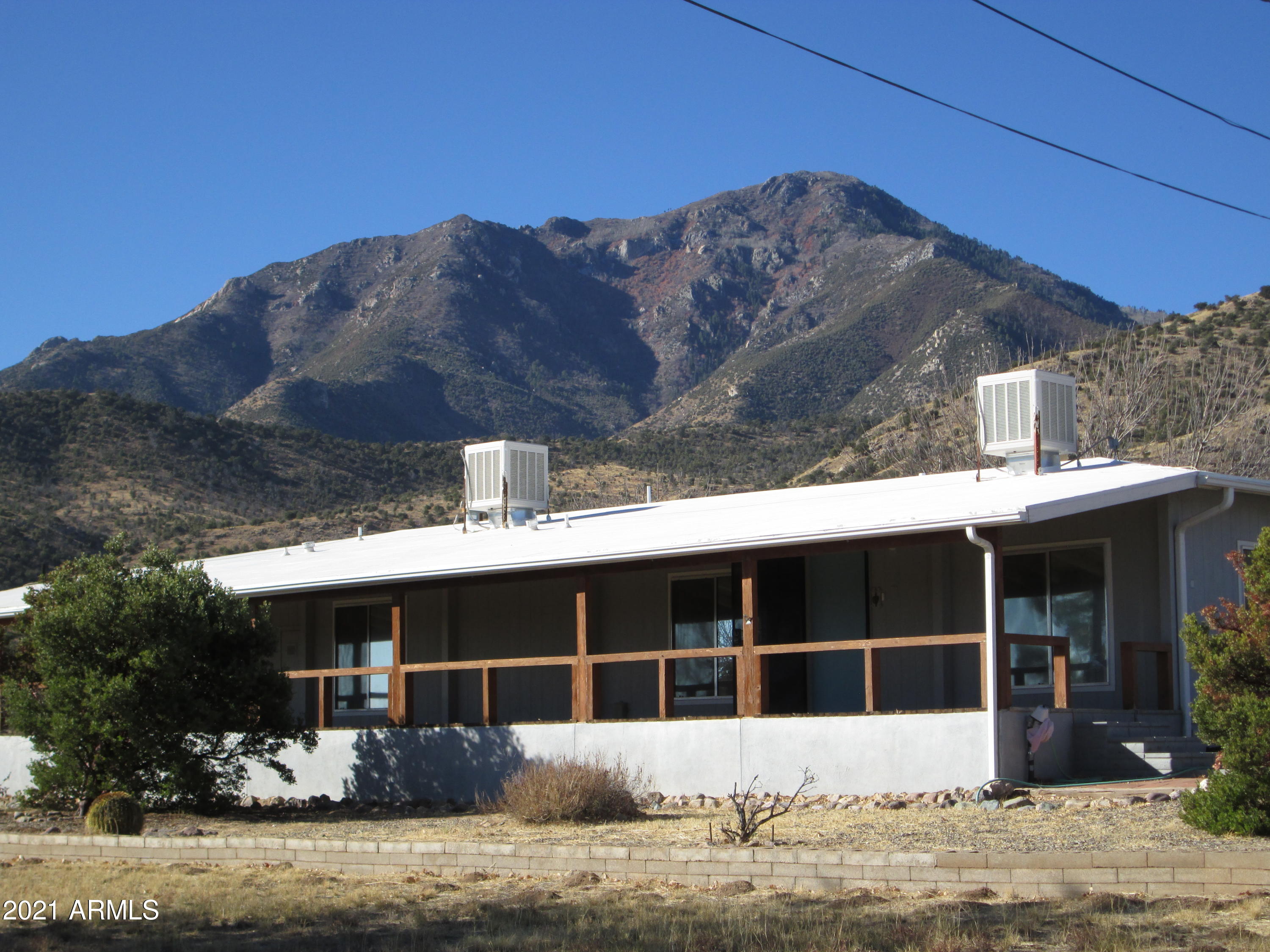 HUGE PRICE REDUCTION! Views, Views, Views! Location, Location, Location! This lovely 4 Bd/2 Ba home sits on 1.54 acres at the foot of the Huachuca Mountains. Grab your morning brew and enjoy the peace and serenity on the covered front porch. This home boasts a HUGE master suite and over-sized walk-in master closet. The 4th Large bedroom with a walk-in closet could be used as a family room, recreation room, craft room or ???  Don't miss the extended1-car garage/workshop with plenty of room for your vehicle, storage & tools. There is also a carport conveniently located near the back door entry. Call for a private viewing of this great home today before it is gone!