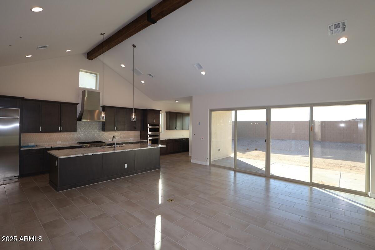 Gorgeous new single-level plan featuring three bedrooms and three-and-a-half bathrooms, along with a courtyard and a split three-car garage.  Modern kitchen with dark cabinets, light  upgraded tops and stainless GE Monogram appliances including a 42'' built-in refrigerator and range top; 16' sliding glass door in family exiting to huge covered outdoor living area; stunning beam at cathedral ceiling in family, dining and kitchen; family room fireplace; utility room cabinets; gorgeous iron front door; owner's bath with floor to ceiling tiled super shower and stand alone soaking tub; upgraded tile, carpeting/pad throughout; 2-tone paint; 2x6 construction and extensive new home warranty.