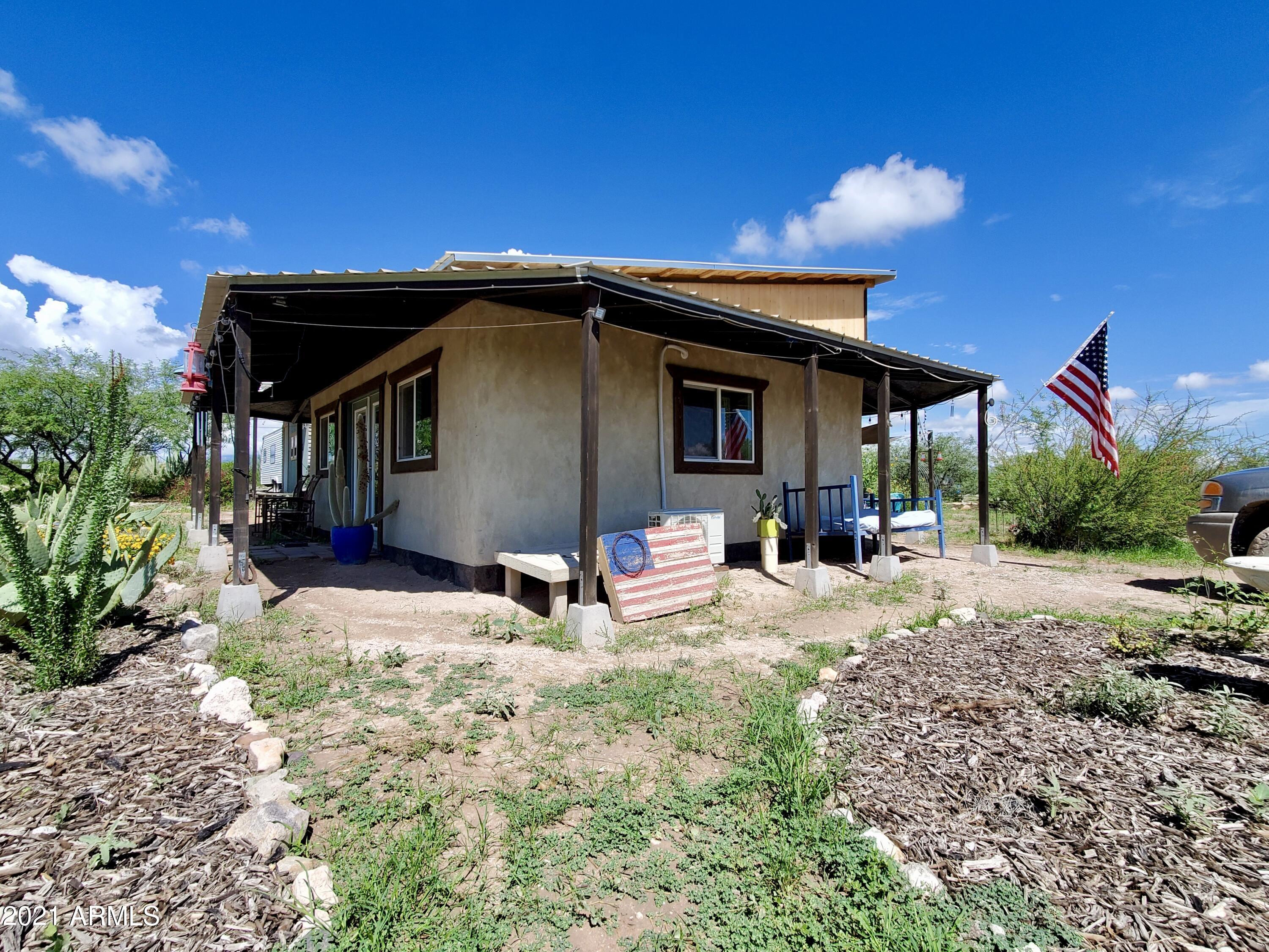 RARE Opportunity!!!  Want to get away from it all and go GREEN!  Turn key off-grid house/farm. This amazing property has a true straw bale home, 40 acres surrounded with mountain views, private well, solar power, storage structures, gardens, pens for goats/chickens/or more.  There is no limit to this property!!! Homesteading Dream!