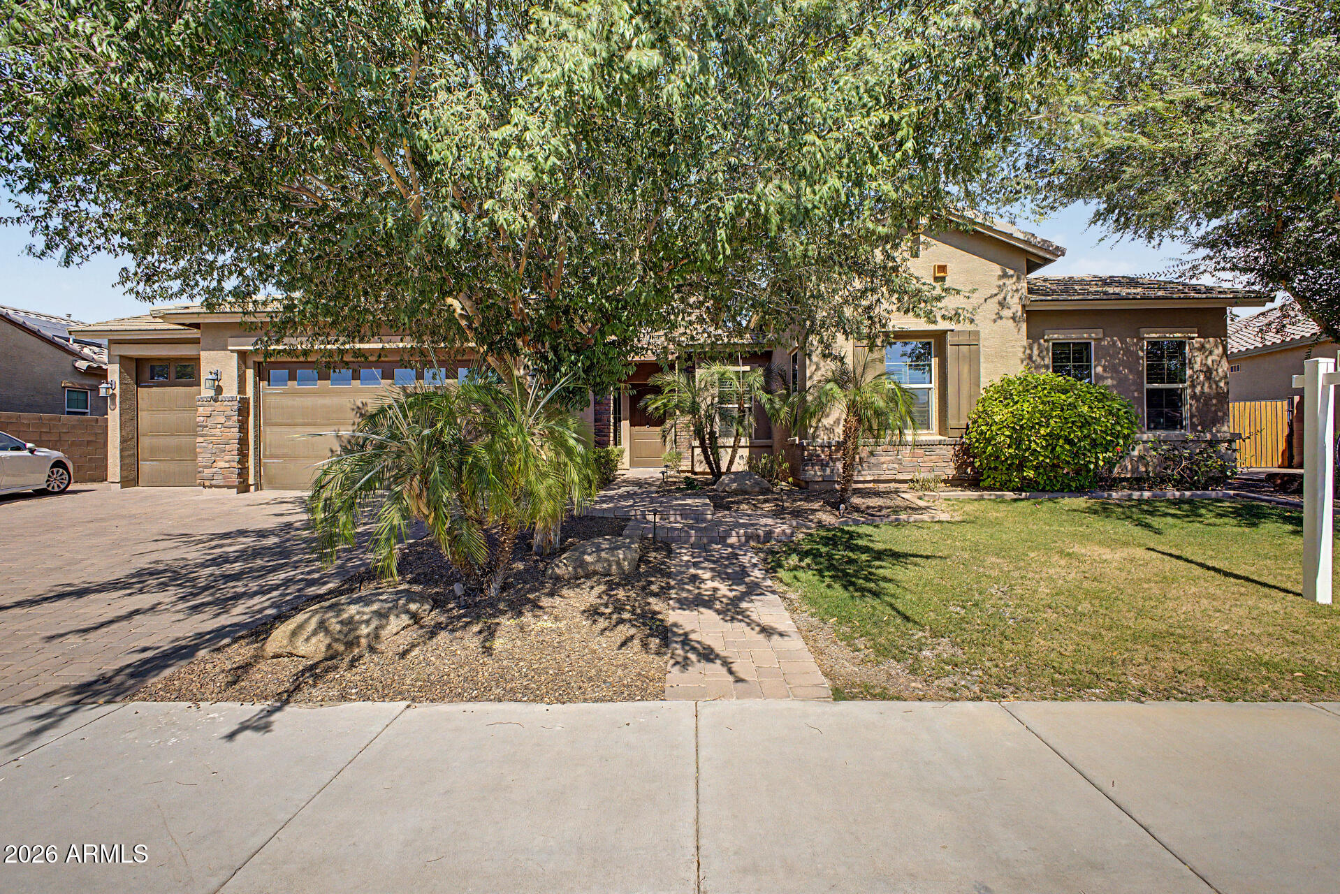 Welcome home to this Maplewood Court residence, featuring a paver driveway, RV gate, and 3-car garage. The home is one of the few in the area that backs up to a private road, offering unmatched privacy and quiet enjoyment.
Inside, wood plank tile flooring, plush carpeting, a formal dining room, den, and recessed lighting complement the living room's cozy fireplace. The kitchen offers abundant cabinetry, granite countertops, stainless steel appliances, tile backsplash, and a large island with breakfast bar. A media room with a built-in screen and sound system adds a dedicated space for entertainment.
The primary suite includes plantation shutters, a granite ensuite bath, and a custom walk-in closet. An additional bedroom with its own private ensuite suits multi-generational living, guests Outside, enjoy a backyard oasis with an extended covered patio, a fire pit, grassy areas, a sparkling pool with removable fence, and spa.
Just steps from the community park and minutes from Chandler's restaurants, markets, medical centers, and vibrant downtown. Schedule your private tour today, homes like this don't last.