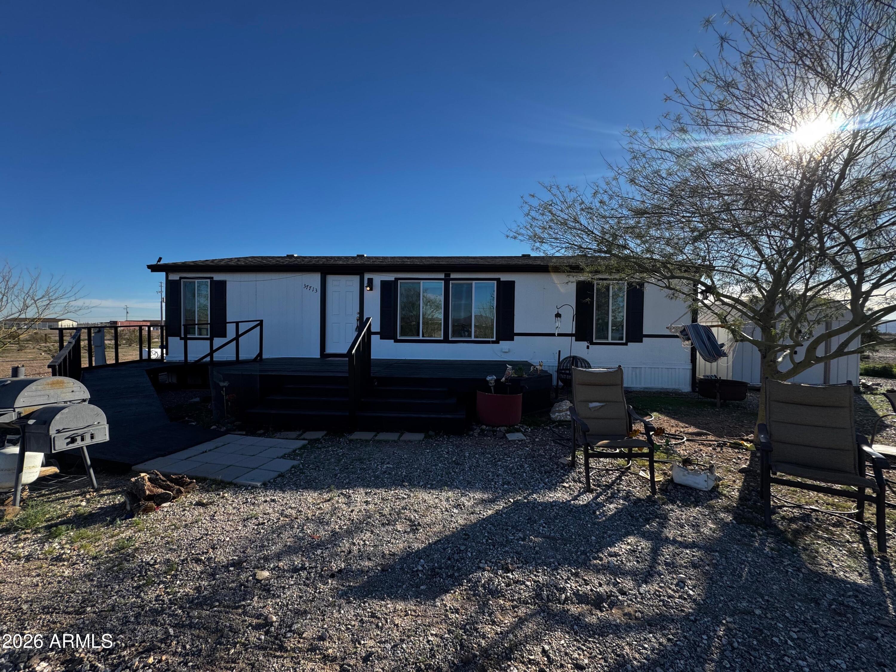 Welcome to your peaceful desert retreat! This charming 3-bedroom, 2-bath mobile home with a private well sits on 2.5 acres of wide-open space in Tonopah, offering stunning mountain views and endless possibilities. Whether you're sipping coffee on the porch or taking in the sunset over the desert, you'll love the quiet, privacy, and room to grow. Bring your RVs, horses, or dreams of homesteading—this property is ready for whatever you imagine.Seller is also willing to sell just half which is 1.25 acres.