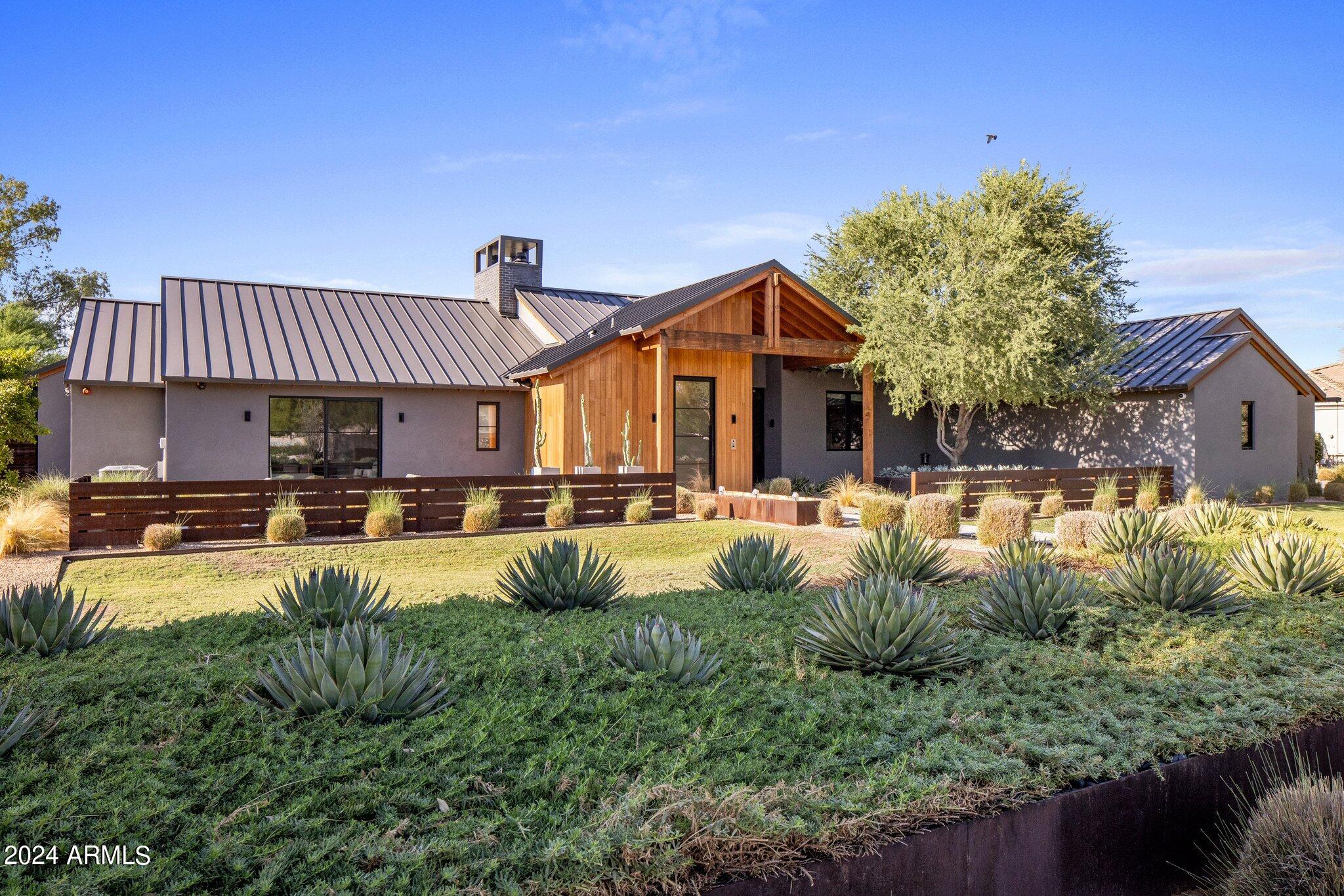 The unexpected home of your dreams ... with the cool of steel combined with the warmth of wood, walls of glass and lush grass.
Estate 48, just like Arizona, the 48th State , Kent Architects designed a strong , unique and warm home that rebels against the expected architecture. 
Brilliant floor plan featuring wide open entertaining spaces, temperature controlled garages with lounge area with sauna.  Oversized storage room with hvac easily can be another bedroom or workout room! 
Serene pool and sun deck , monster spa , bocce ball and deep covered patios. 
Endless opportunity to expand beyond the current back steel fencing.