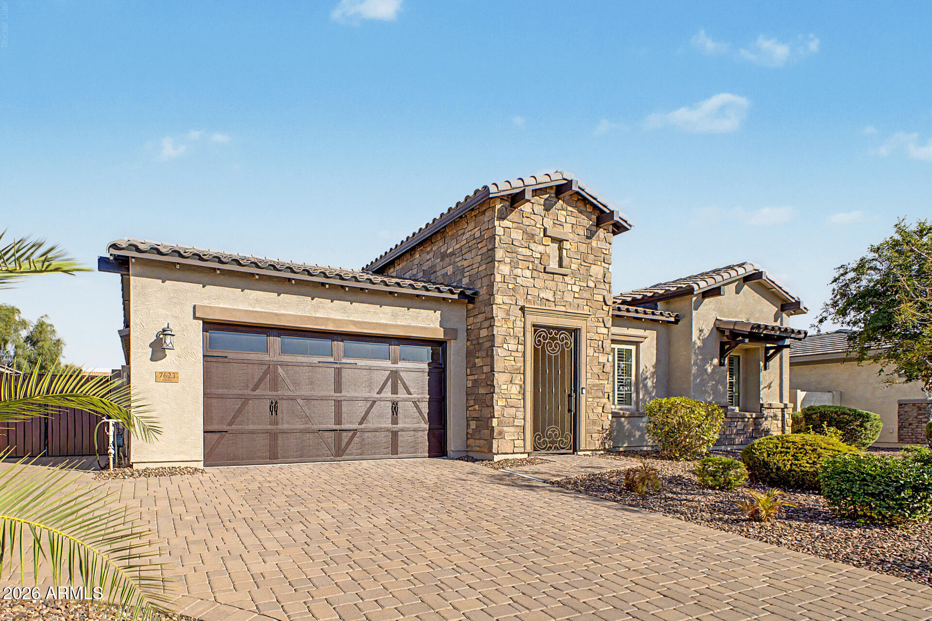 Experience luxury living in The Preserve at Adora Trails. This exceptional Maracay home offers the perfect blend of elevated design, thoughtful functionality, & energy-efficient living w/ its LEED Certified construction. Featuring 4 spacious bedrooms, 3 full bathrooms, a private den & a versatile flex/bonus room. From the moment you arrive, the inviting front courtyard, extended paver driveway & impressive curb appeal set the stage for the quality found throughout the home. Inside, the desirable split floor plan provides privacy & functionality while the soaring 12-foot ceilings in the great room create an open  dramatic living space filled with natural light. Thoughtful upgrades include plantation shutters, designer lighting & abundant storage throughout. The gourmet kitchen is designed for both everyday living & entertaining, featuring extensive cabinetry, ample counter space, & seamless flow into the great room. The spacious primary suite provides a private retreat w/ a large walk-in shower, generous closet space & a relaxing atmosphere. Secondary bedrooms are generously sized, while the dedicated den & a flex room offer endless possibilities for a home office, media room, gym, playroom, or additional living space.
Designed for Arizona's indoor-outdoor lifestyle, the backyard is a true retreat featuring a heated pool with cascading waterfalls, a large covered patio & mountain views. With no neighbors behind, enjoy added privacy while relaxing, entertaining, or taking in Arizona's spectacular sunsets.
The 3-car tandem garage offers exceptional storage and functionality w/ epoxy flooring, upper storage racks, a side entry door & space for vehicles, hobbies, & more. Additional features include a water softener, reverse osmosis system, and pre-wiring for surround sound in the great room and patio.
The Preserve at Adora Trails offers a true lifestyle within one of Gilbert's premier master-planned communities. Residents enjoy a low HOA with access to a clubhouse featuring a full fitness center and studio for live classes, a heated pool with splash pad, miles of walking trails, basketball courts, playgrounds, and year-round community events including weekly food trucks. With an onsite elementary school and close proximity to Gilbert Regional Park, Adora Trails offers the perfect blend of recreation, convenience, and community connection.