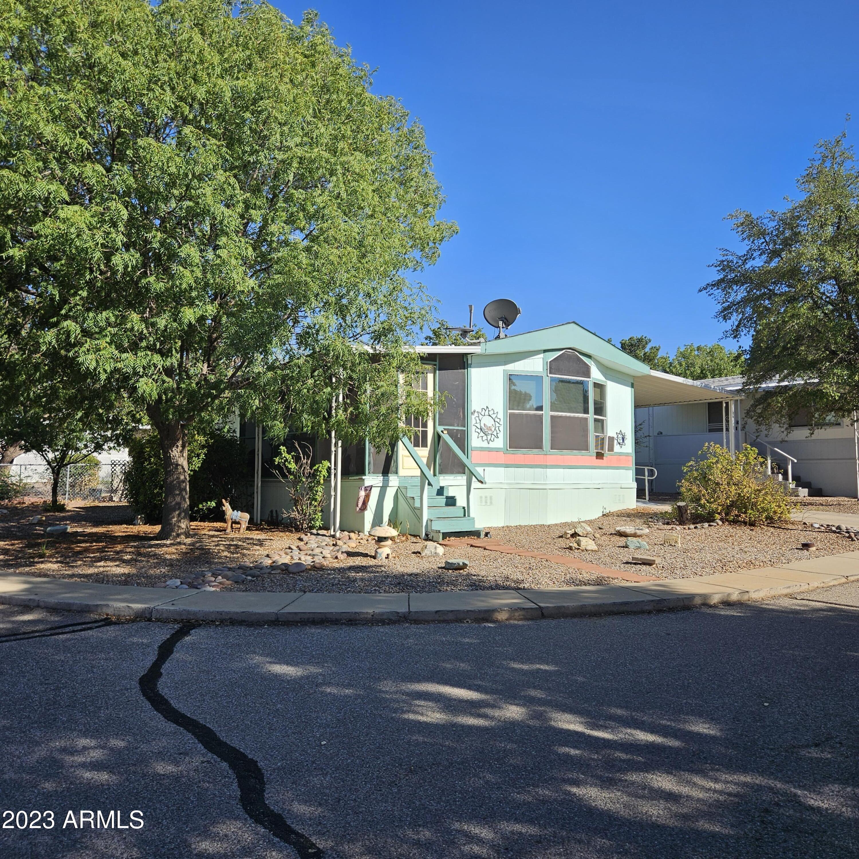 Cute, cute, CUTE!!! This home feels bigger than its actual square footage! Large windows, open floorplan and light colors all help to achieve a very comfortable and friendly space. Very comfortable screened in Sunroom. Master Bedroom has built in 8 drawer dresser with closet above and built in base and overhead cabinets! Concrete skirting. Newly installed Aluminum Ramp for easy access. Located in a gated community with indoor pool, spa and outdoor pool. 2 clubhouses and many amenities.