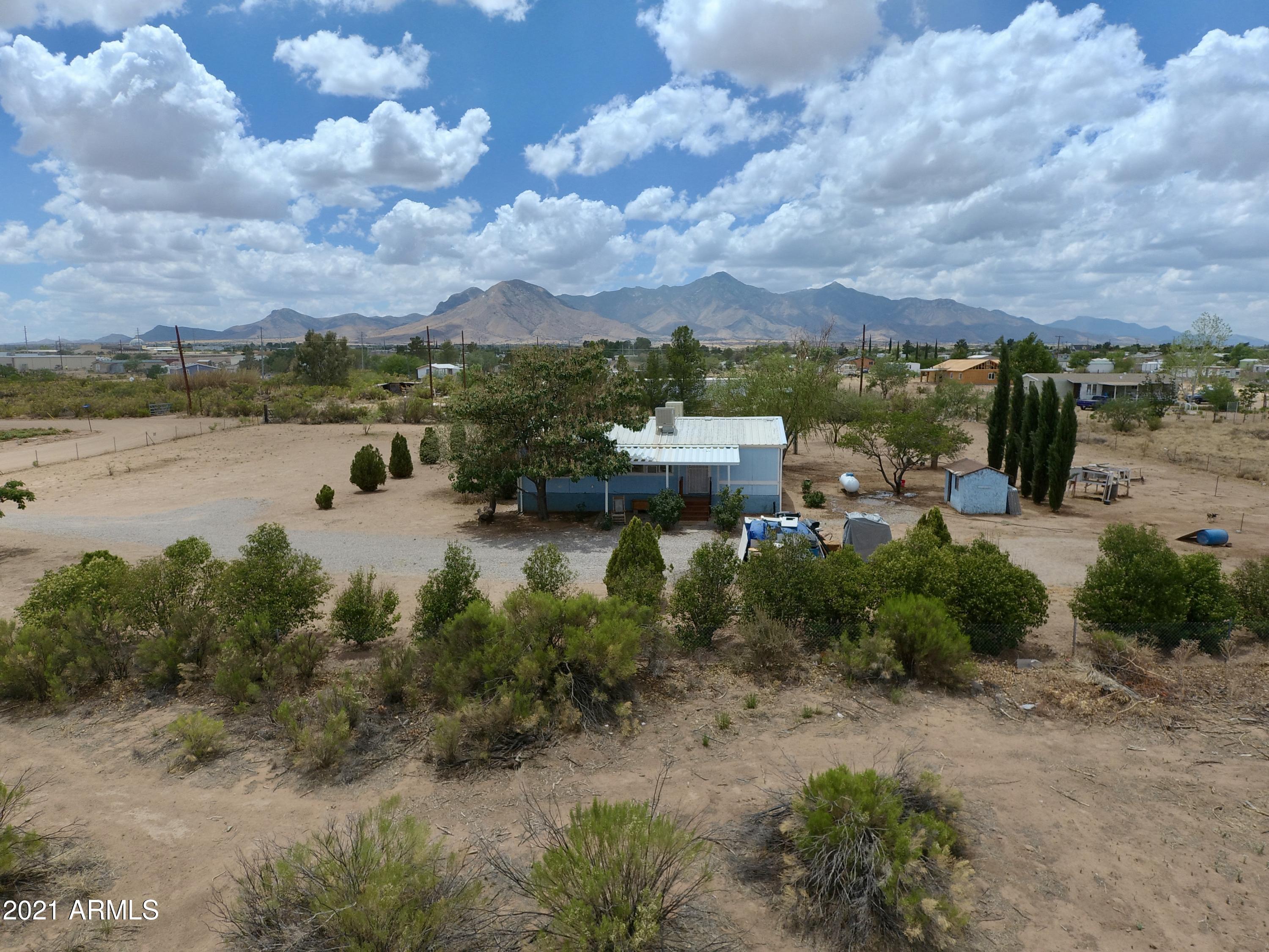 Adorable 3 bedroom, 2 bathroom home that sits on a little over one acre.  The home has the Affidavit of Affixture, has engineered tie downs, and septic inspection. No HOA, limited CC&R's.  Wonderful mountain views of the Huachucas, Mules and even Chiricahua in the distance on a clear day.  Short drive off of a paved road, gated entrance, and fully fenced property.