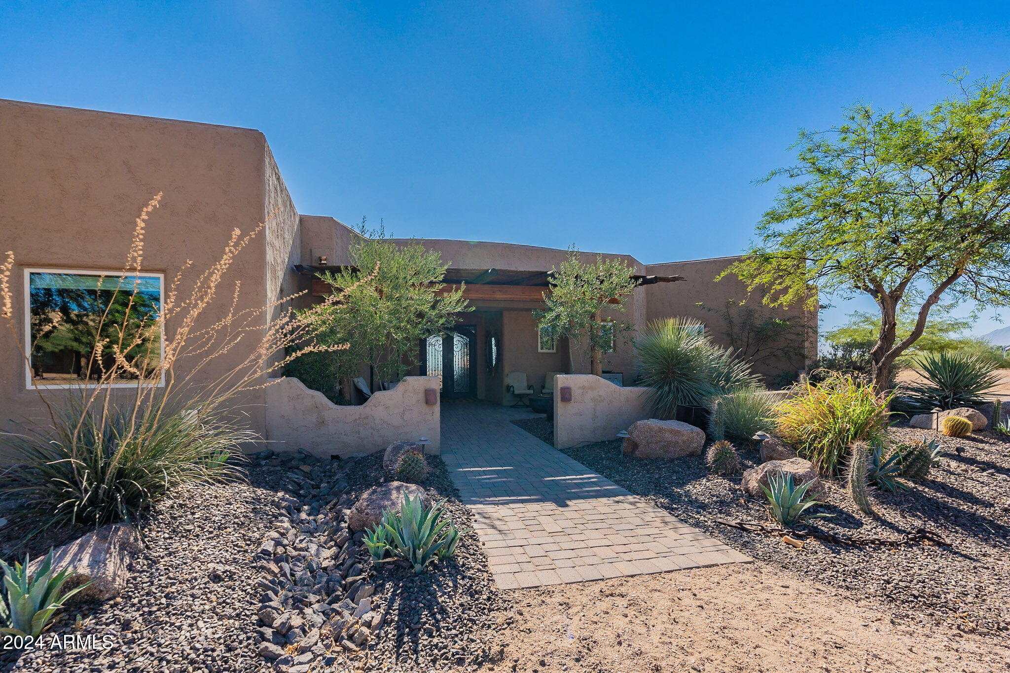 Stunning Equestrian Estate with Guest House nestled on a sprawling 10 Acre property in the serene landscape a short distance from the Tonto National Forest. New roof w/12 year warranty  
This property offers an exceptional blend of modern comfort, views, and exceptional Equestrian facilities.
This 3bedroom, 2.5 bath home with open floorplan, showcases a chef's kitchen featuring a gas range, granite counters, custom cabinetry, newer microwave and dishwasher.
Master split to one side with direct access to rear patio, two additional spacious bedrooms. Large Greatroom with Gas Fireplace and walls of glass opening up to the beautifully landscaped green rear yard.
Enjoy the Outdoor beauty of Arizona year round with the deep wraparound covered patio looking east towards the iconic Four Peak Large Heated play pool with Boulder Water feature. Separate above ground spa. Back yard is surrounded by block wall covered in white rose vine creating a private oasis. The views are unobstructed and panoramic of the mountain ranges to the east as the land gently falls away. Four Peaks, Weavers Needle, Bartlett Dam all in full view.
The separate Guest House features 2BR, 2BA with full kitchen and large living space. In addition the owners created unique lodging converting a container into a charming guest suite with outdoor shower and toilet. If you have an RV or friends coming to stay there is one RV full hookup with electric, water, and sewer.
Top Notch Professionally Designed and Built Equestrian Facilities with 7 stall shed row style Block barn with deep overhang. Each stall is fitted with rubber mats, fan, mister and fly control system, and excellent lighting.  Runs off back of each stall if you prefer them going in and out or you can shut the back door to keep them inside. Large Airconditioned tack room with built in saddle and bridle racks and storage. Mud room can double as grain/feed room with deep sink, refrigerator, storage cabinets and plumbed for washer/dryer. Outside wash rack with hot water piped in. The entire 10 acres is perimeter fenced with Rustic oil pipe fencing. Your horses will love the 8-pipe fenced turn out paddocks with shades with room to add more. Large steel container to store hay.  Dressage size arena with rubber/sand footing and an additional large, cleared area if you need something a bit larger, plenty of room and lot coverage left to build a large Covered Arena.  Round pen with sand footing. You will love the direct access out your gate to miles of trails with soft decomposed granite footing NO ROCKS! Just a short 10-minute trail ride to Tonto National Forest for scenic trail riding.
Do you love gardening and fruit trees? Wonderful Herb Garden and talk about trees! Fruit trees planted include Lemon, Lime, Peach, Apple, Guava, Fig, Kumquat, Grapefruit, Blood Oranges, Pomegranate all on drip system and not just any drip system this system has automated fertilizer system added so trees are slow fertilized in spring and fall with the watering system and they are thriving!
Utility rates are on the rise, so problem has been solved with Solar Panels (owned) that keep those bills at or under $300 a month. Located in Maricopa County where property taxes are low, Scottsdale Mailing address, and a good producing Private well with newer pump installed this property has it all.
Perfect for any equestrian or outdoor enthusiast your perfect oasis in the desert. Solar panels owned not leased low bills!
