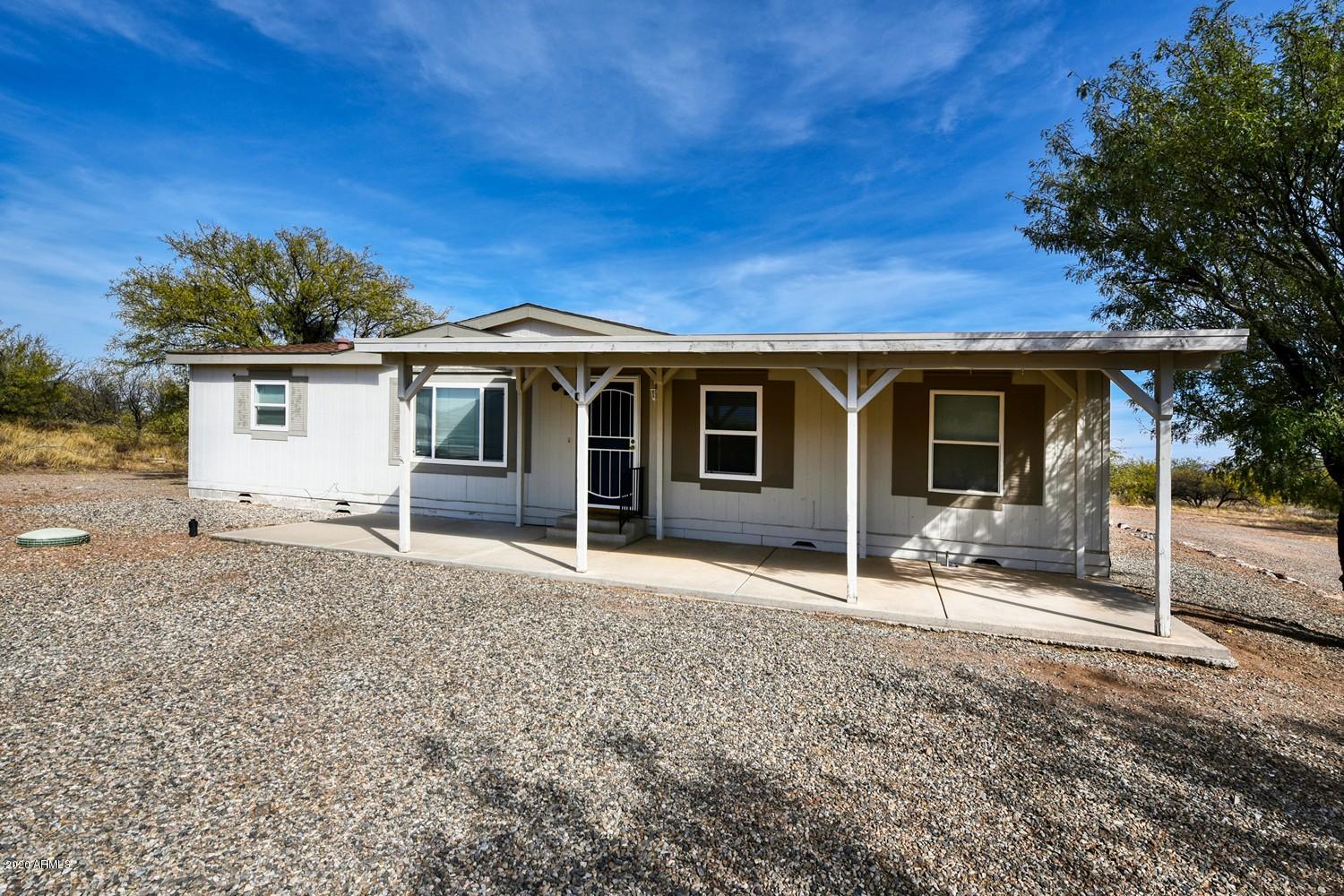 MOVE IN READY HOME!!!! You have to see this 3 bedroom 2 bathroom manufactured home nestled on 2.3 acres with views of the Huachuca Mountains out your front door steps. Near the back of the property you will find a large metal workshop with a roll up garage door and a single entry door. Both electric and water are ran to the shop. Property is full fenced with a large entry way with a circle drive way. Inside the home you will find a split floor plan with the master on the west side of the home and the other two bedrooms on the east side of the home. The living room and the kitchen are in the middle of the home. Kitchen has newer cabinets and newer flooring. In the master bathroom you will find a large garden tub, separate shower stall and double sinks. Call me for a private showing!!!
