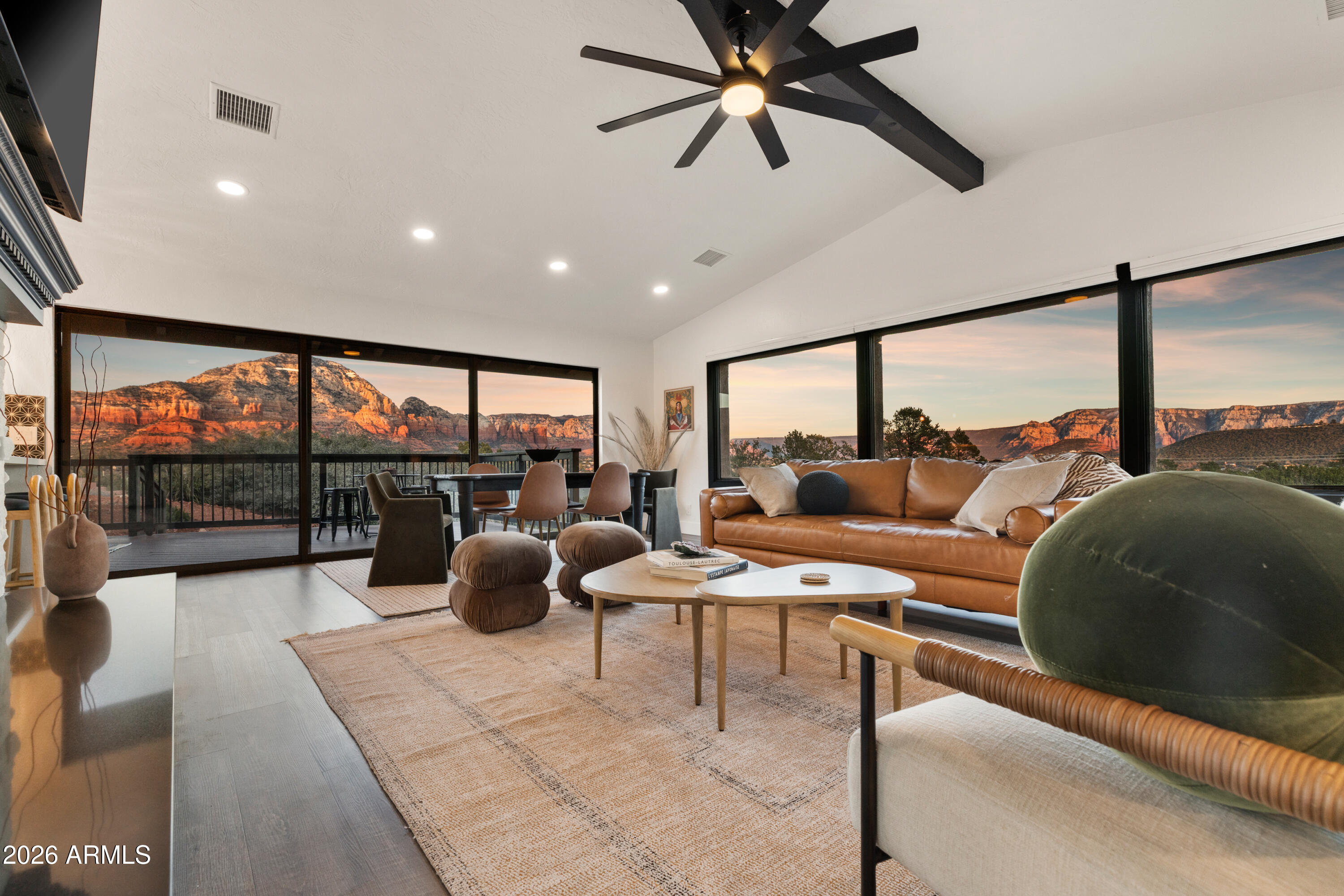 Listing price includes the adjacent .66-acre parcel for a combined 1.15 acres, amplifying privacy and presence of this special home. 

Elevated above the glittering city lights of Sedona with unobstructed 270° red rock vistas, this fully reimagined contemporary home has 3BD/2.5BA + a lower level flex bonus room.  It delivers the trifecta of updated design,  a gorgeous lot, and transcendent scenery. 

Picture windows flood the open-concept living space with natural light and ever-changing desert color. Remodeled inside and out, the home features clean lines and expansive open decks, creating effortless indoor-outdoor flow. 

Beautifully staged to highlight its city-meets-nature setting. 

The owner holds AZ Real Estate Broker License.

MORE DETAILS+PHOTO NARRATIVE: --------------

300 CALLE DEL NORTE HIGHLIGHTS & DETAILS:

Originally built in 1986 and intentionally positioned to capture the full sweep of Sedona's majestic red rock skyline, this home has undergone a thoughtful top-to-bottom transformation over the past three years. What once stood as a well-sited property with strong bones in the highly desirable Foothills South neighborhood is now a fully reimagined contemporary retreat -- refined, cohesive, and intentionally modern.

Every surface has been reconsidered. Interior and exterior renovations were executed with an emphasis on clean lines, durability, and bright, neutral finishes. The result is far more than cosmetic improvement -- it is a true reinvention, blending modern influence with the warmth, proportion, and scale that Sedona living demands.

The surrounding grounds received equal attention. Landscaping was groomed and reshaped to create a cohesive 1.15-acre setting with walking paths (inclusive of the adjacent parcel), increasing usable outdoor space while preserving the natural beauty that frames the panoramic views -- offering a private, park-like environment. A generous horseshoe driveway enhances both arrival presence and functionality, accommodating up to 6 vehicles.

Set along West Sedona's main corridor, the property enjoys immediate access to town amenities and thoroughfares, making daily living and entertaining effortless. Elevated above the roadway, the home captures uninterrupted red rock vistas and city lights, pairing convenience with commanding views.

With the inclusion of the adjacent parcel, the expanded 1.15-acre footprint opens the door to enhanced outdoor design opportunities. A future owner may choose to incorporate additional privacy landscaping, architectural screening elements, water features, fountains, or even a pool and spa environment -- further enriching the sensory experience of the outdoor spaces. Mature plantings, rustling trees, and thoughtfully designed hardscape features could create an even more immersive and layered landscape setting while preserving the property's panoramic outlook. (Buyer to verify expansion options with the HOA and compliance with all applicable CCRs.)

Without exception, this is a property that has been carefully curated -- not flipped or rushed -- but deliberately refined by the seller, who lived in the home and personally served as the general contractor for the remodel.

Explore the immersive 3D walkthrough and cinematic video tour to fully experience the layout, elevation, and panoramic view corridors this property offers.

Continue to take a closer look at the layout, materials, improvements that define this property. All of the heavy lifting and expense has been taken care of for the new owner.

NEW STRUCTURAL & MECHANICAL IMPROVEMENTS (2023-Present)
-Composition shingle roof
-Exterior Paint - Beige stucco with black trim accents
-HVAC system including new ductwork and the addition of central air conditioning
-Dual-pane energy-efficient windows and main sliding glass door
-Electrical updates throughout with all new interior and exterior lighting

NEW EXTERIOR ENHANCEMENTS (2023-Present)
-2 new decks with composite plank floors +wood rails & bannisters
-New asphalt driveway
-Added Retaining walls and expanded hardscaping improvements
-Added paver patio off third bedroom with enclosed pet area
-Added upper yard paver patio creating additional outdoor space

NEW SITE WORK & DRAINAGE (2023 to Present)
-Comprehensive landscaping refresh with new decorative rock and gravel
-Added groomed walking paths throughout the property
-Added drainage channels and French drain systems installed for improved water management

GARAGE & STORAGE (2025/26)
-Full 2-car garage remodel including fresh paint, epoxy-coated floors, new garage doors, and quiet-open openers + coded entry pad
-Expansive crawl space maintenance with groomed earth floor, lighting, w/fully sheathed walls & ceilings for mechanical protection and insulation integrity - TONS OF STORAGE!

INTERIOR RENOVATIONS (2023-Present)
The interior renovation reflects a cohesive, modern design palette centered on warmth, contrast, and functionality.

INTERIOR FINISHES & DESIGN FEATURES
FLOORING & PAINT
-Whole-home luxury vinyl plank flooring in a dark walnut tone
-Five-inch white baseboards throughout
-Bright white interior paint with updated wall texturing
-Warm, dense oyster-toned carpet in the primary suite & Bedroom 2

LIVING & ENTERTAINING SPACES
-Open-concept living and dining areas adjacent to a spacious corner kitchen
-Wood-burning fireplace with stone ledger accent wall and a black quartz hearth creating a striking focal point
-Flooded with light coming in the large format wood encased picture windows and trimmed out w/black accent paint
-Whole-home new doors, hinges, and hardware
-Whole-home new lighting including plates, switches, receptacles

KITCHEN
-White quartz countertops w/gorgeous geometric starburst tile backsplash with metal button accents
-Extensive white shaker-panel cabinetry, upper & lower with soft-close doors and drawers
-Brushed bronze cabinet hardware
-Ceramic apron-front sink w/gooseneck faucet with pull-down sprayer + a dedicated pot filler faucet
-Air button disposal
-White Matte-finish Café appliance suite with bronze-accent hardware includes: Built-in microwave, Dual-oven electric range w/induction cooktop, Double upper-door refrigerator with dual lower freezer drawers, Dishwasher

BEDROOMS & BATHS
Primary Suite
The en-suite primary bedroom offers a warm, intimate retreat with plush carpet underfoot and direct access to the front view deck via sliding glass doors. Brushed bronze wall sconces, recessed lighting, and a ceiling fan provide layered illumination. Storage is generous, featuring a double mirrored closet with interior shelving systems in addition to a separate walk-in closet.

The three-quarter primary bath showcases hex tile flooring + a beautifully tiled walk-in shower with smaller-format hex tile floor and large-format marble tile extending up the walls. A brushed bronze waterfall showerhead with separate handheld sprayer enhances functionality and design cohesion. The dual-sink vanity features white shaker cabinetry, quartz countertops, brushed bronze hardware, individual mirrors, and glass-bead double wall sconces for a refined finish.

Bedroom Two
Offers plush carpet, fresh finishes, and two new vinyl windows overlooking the backyard. Recessed lighting, a ceiling fan with integrated light, and a traditional closet provide comfort and practicality.

Bedroom Three
Features plank flooring and a thoughtfully organized closet system. A sliding glass door opens directly to a private paver patio which is enclosed and ideal for pets or a contained outdoor retreat. Recessed lighting and a ceiling fan complete the space.

Guest Bath
Conveniently located between Bedrooms Two and Three, the full-sized guest bath has luxury vinyl flooring and includes a shower/tub combination with textured white tile surround up the walls. A dual-sink vanity mirrors the finishes of the primary suite, maintaining continuity in cabinetry, quartz countertops, and brushed bronze accents.

LAUNDRY SPACE
Newly added upper-level laundry room for convenience with front load washer & dryer included; with a butcher block counter top for folding area; door can be closed for visual privacy.

LOWER LEVEL FLEX SPACE
The lower-level flex room was thoughtfully added by the owner, expanding usable square footage off the garage and designed cohesively with the rest of the home. Finished with plank flooring, high white baseboards, and bright white walls, the space feels integrated rather than secondary. A window was added to provide natural light and egress.

Built-in bench seating and a compact kitchenette with sink and mini refrigerator create functional versatility -- ideal as a post-workout smoothie station, or creative studio setup. The addition also includes a newly constructed half bath with single-sink vanity. Fully heated and cooled, the space offers year-round comfort and flexibility. Well-suited for a fitness or wellness room, artist studio, media retreat, or private yet inviting home office.

With panoramic red rock views, extensive capital improvements, expanded acreage, and a thoughtfully executed modern remodel, 300 Calle Del Norte presents a rare opportunity to own a fully realized Sedona retreat -- where design, land, and location align in one compelling offering.
