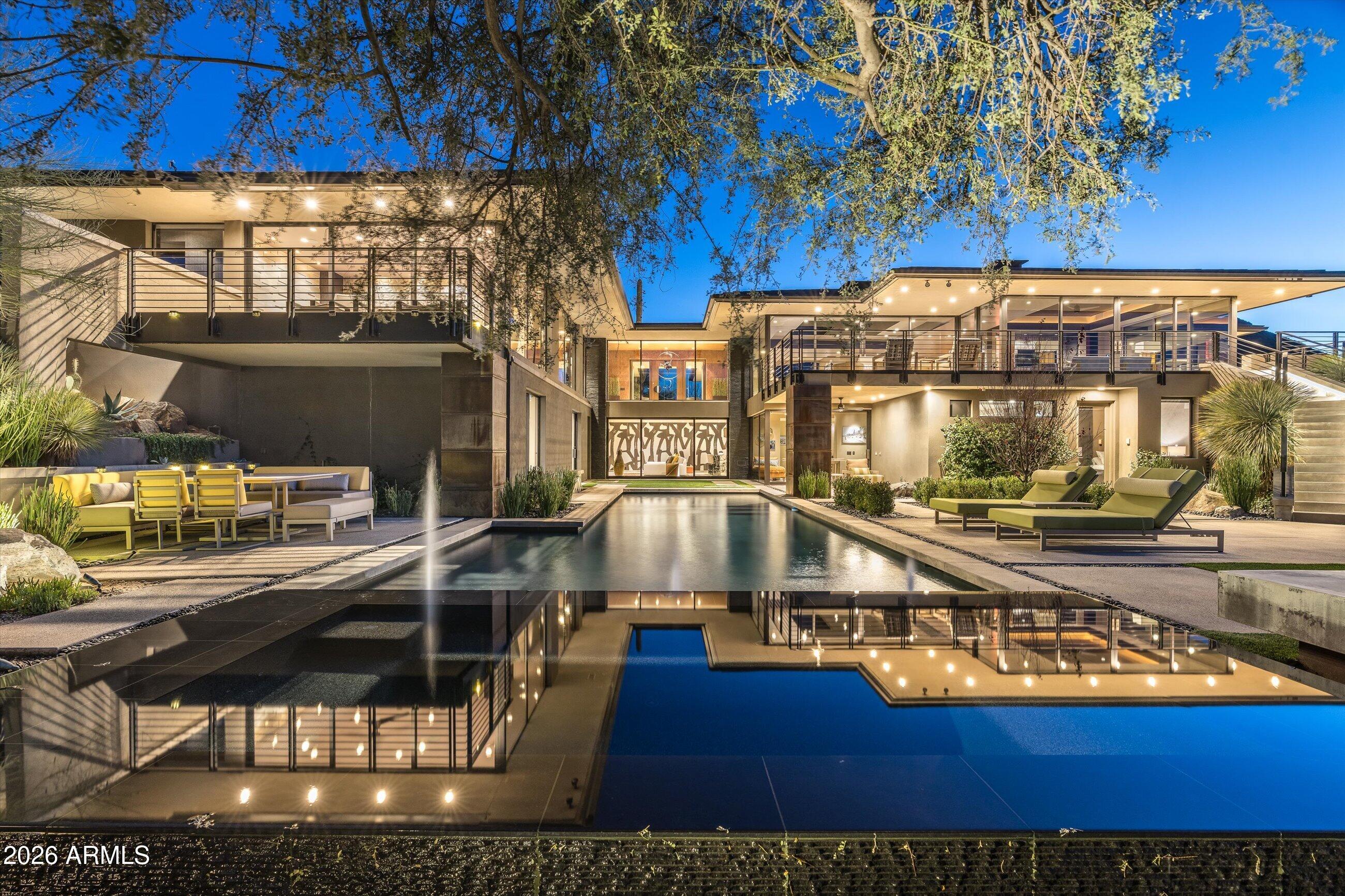 ONE-OF-A-KIND CONTEMPORARY MASTERPIECE  with Golf Membership available!, located within the prestigious, guard-gated Desert Mountain Club community spanning over 8,300 acres of pristine Sonoran Desert beauty. Perfectly positioned on an elevated, ultra-private .85-acre lot, this exceptional estate captures sweeping panoramic mountain, city light, golf course, and sunset views, overlooking the 5th hole of the Geronimo Golf Course.
This stunning residence offers 5-7 bedrooms, a 4-car garage, and an attached 1,021 sq ft private casita, all designed around a desirable main-level living floor plan with the added convenience of a private elevator. No expense has been spared in the designer-inspired interior and exterior remodel featuring all-new custom cabinetry, Sub-Zero and Dacor appliances, dramatic floor-to-ceiling glass walls, whole-home surround sound, a temperature-controlled wine room, dedicated gym, private bar and game room, and a spa-inspired primary suite with sauna.
Step outside to your own private resort oasis showcasing a PebbleTec pool and spa, tranquil water features, expansive entertaining areas, and unmatched desert serenityideal for both relaxation and hosting unforgettable gatherings.
Located within ½ mile of the Desert Mountain Clubhouse, owners enjoy access to world-class amenities including championship golf, tennis courts, pickleball, lap pool, spa services, state-of-the-art fitness facilities, bocce ball, and multiple dining venues. Desert Mountain is home to the world's largest collection of private Jack Nicklaus Signature Golf Courses,nine distinctive restaurants and grills, and is consistently recognized by Platinum Clubs of America as one of the top private clubs in the nation. The community is also proudly designated as a Blue Zone® lifestyle community, promoting longevity, wellness, and active living.
Golf Membership may be made available to the Buyer with Club approval and additional fee. Seller is willing to include the Golf Membership with the right offer.
A rare opportunity to own a true architectural statement combining luxury, privacy, lifestyle, and breathtaking views in one of North Scottsdale's most coveted communities.