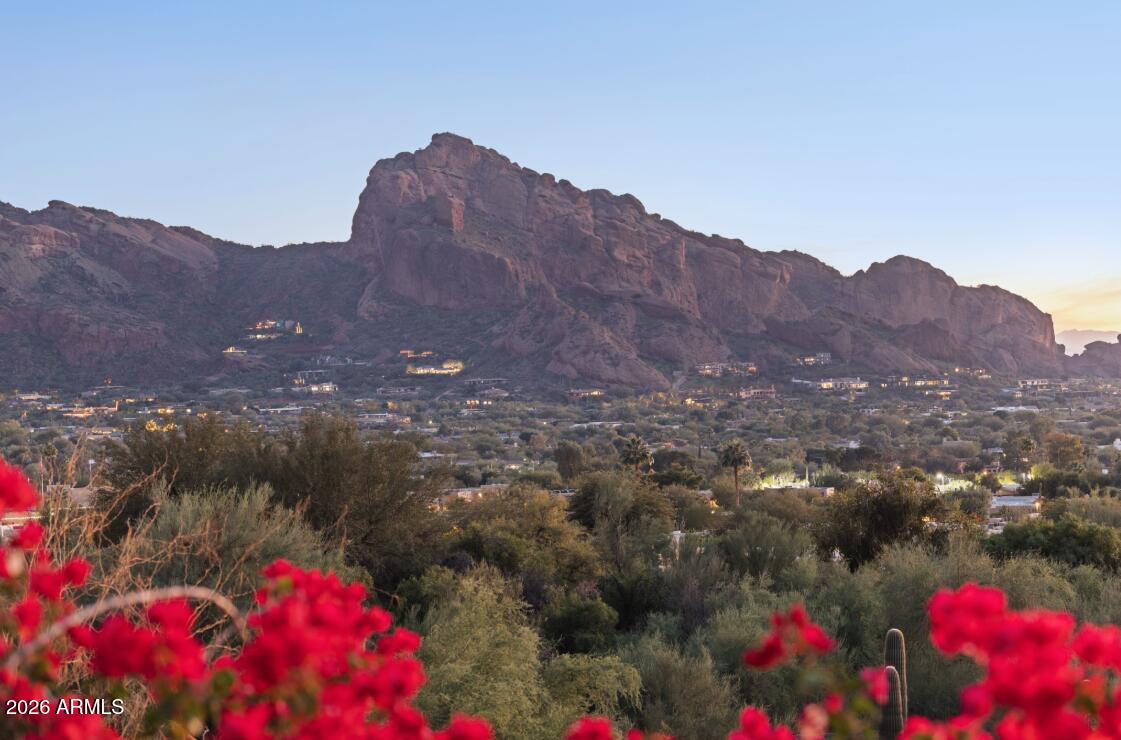 This spectacular lot captures breathtaking, unobstructed views of the full Camelback Mtn, sparkling Downtown Phoenix skyline, and Paradise Valley Golf Course. This exceptional 1.6 acre homesite offers the rare combination of  extraordinary panoramic views and a walkable area near prestigious Paradise Valley Golf Course.
Additionally Conceptual plans for a 9,200 sqft, single level residence with no interior steps and an 80ft pool on the same level, have already completed an initial hillside committee review. (It also has additional property for 10 cars and a wellness center). There is a current home and tennis court on the existing property.